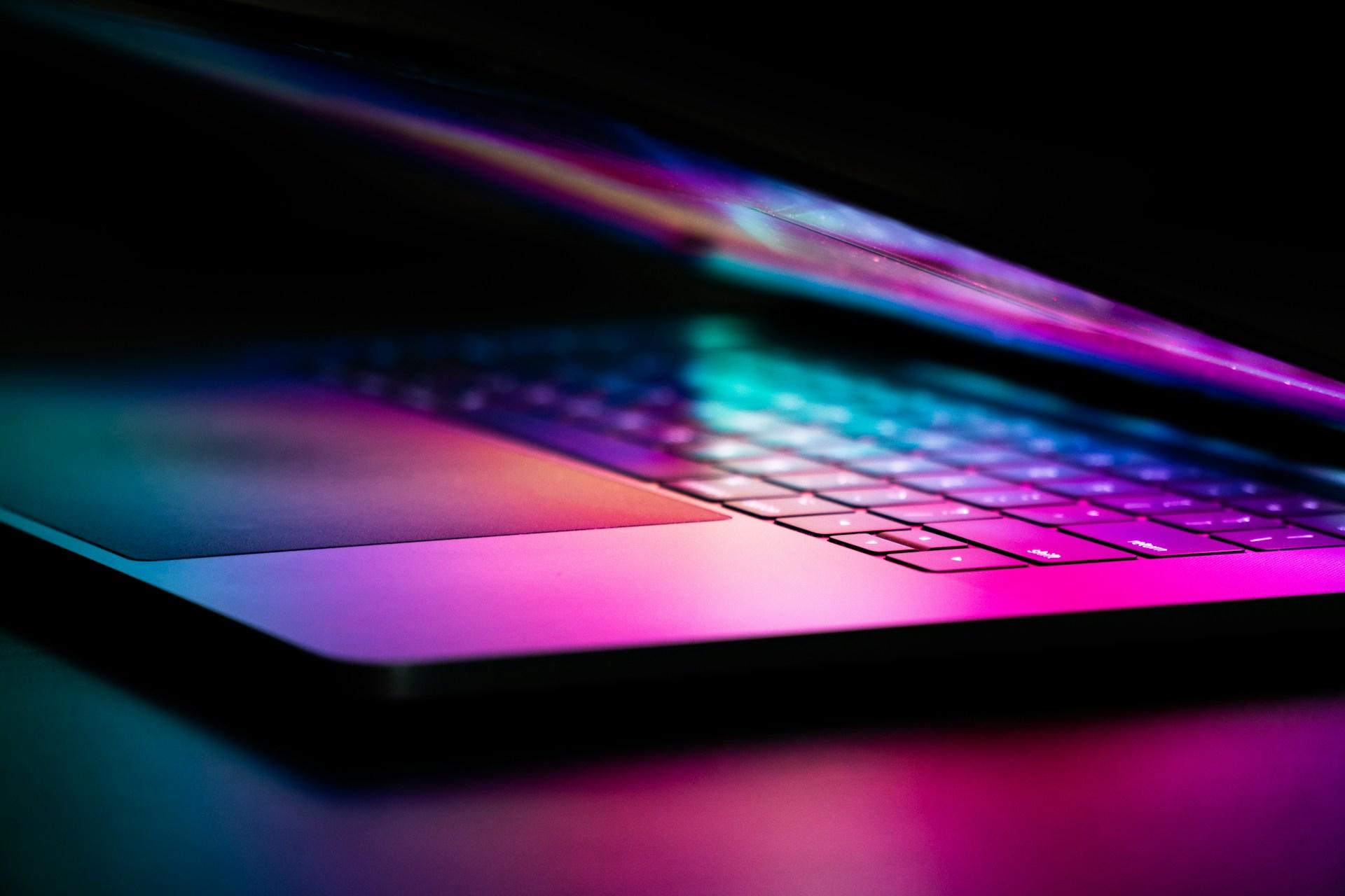 A closeup of a laptop case opening in the dark.