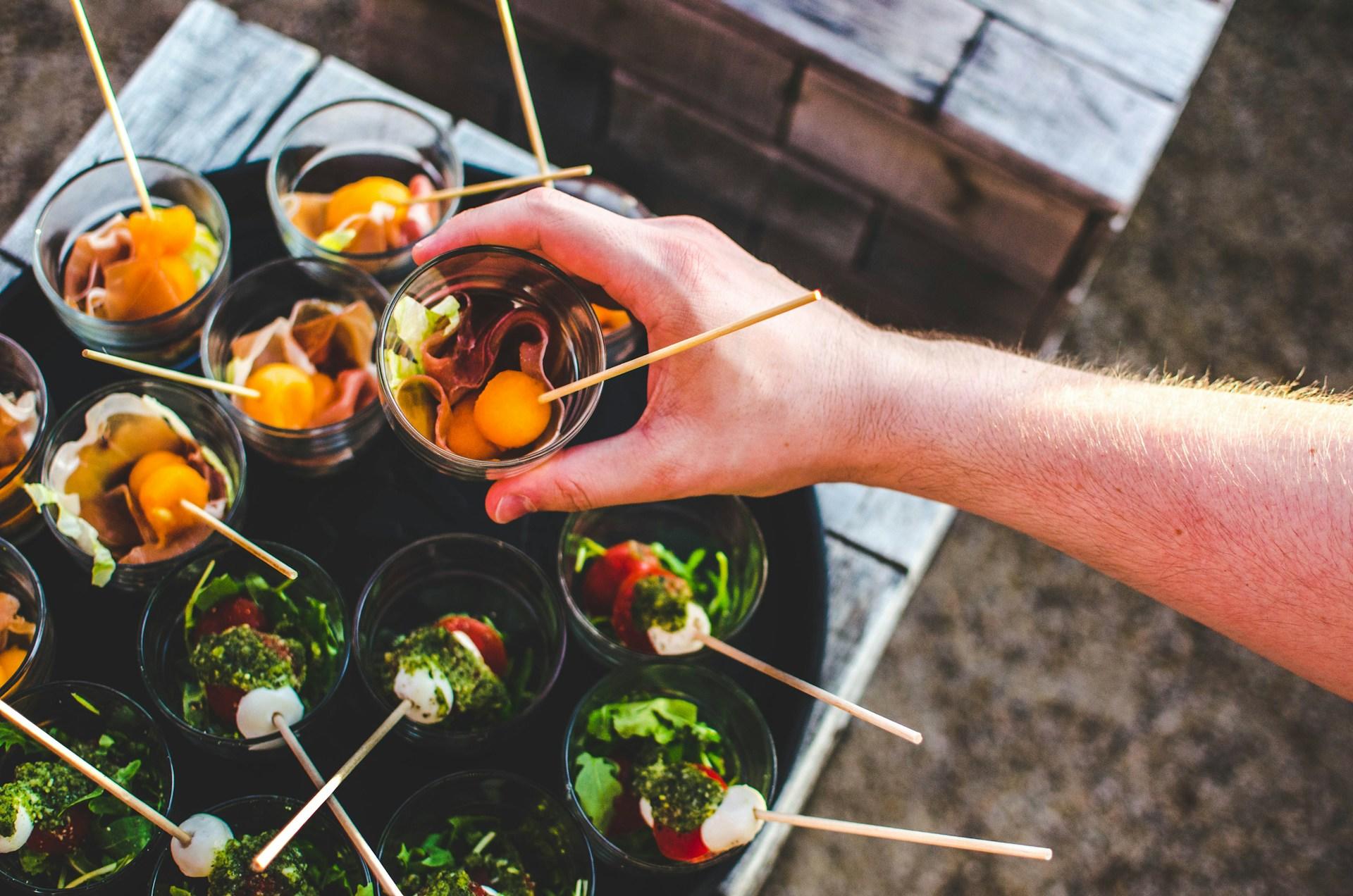 Catering staff with a tray of hors-d'oeuvres.