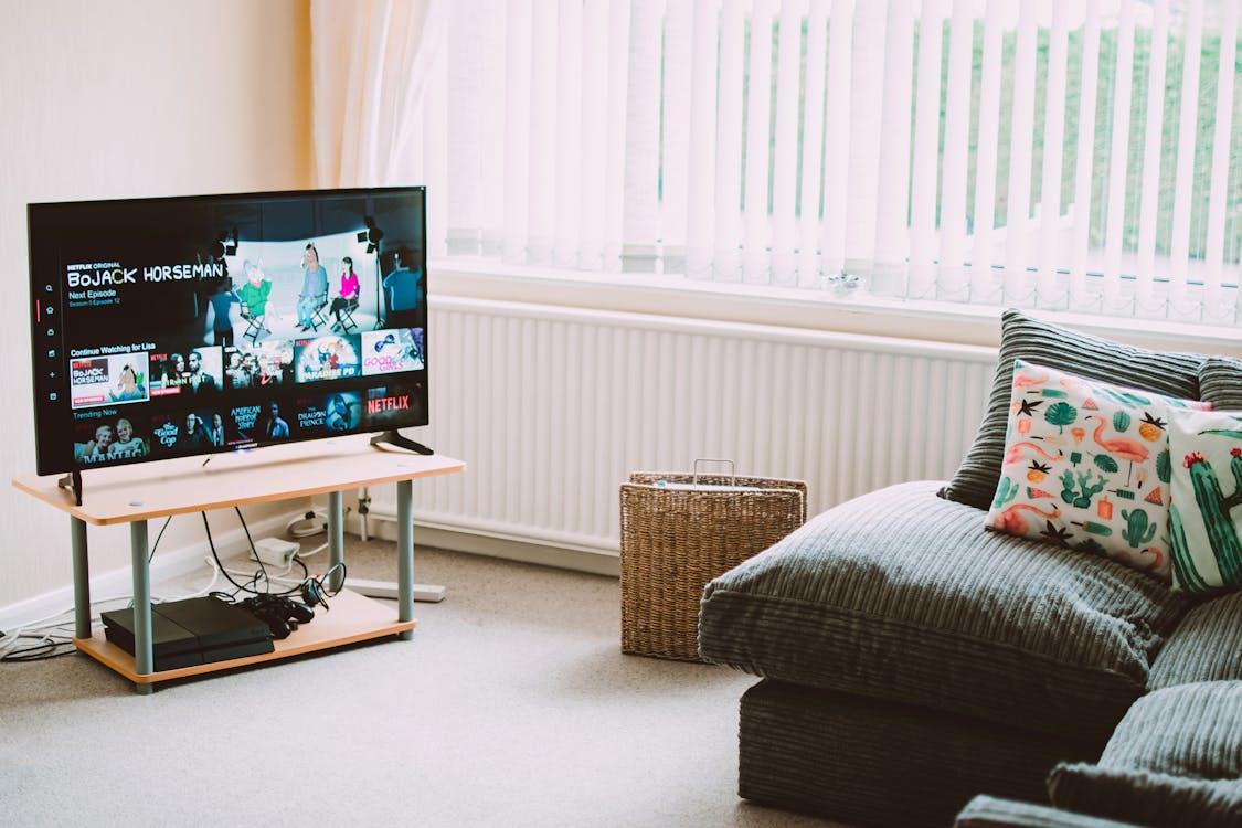 A sleek flat-screen smart television stands prominently in a living room, promising endless hours of entertainment for fans of Irish TV shows. 