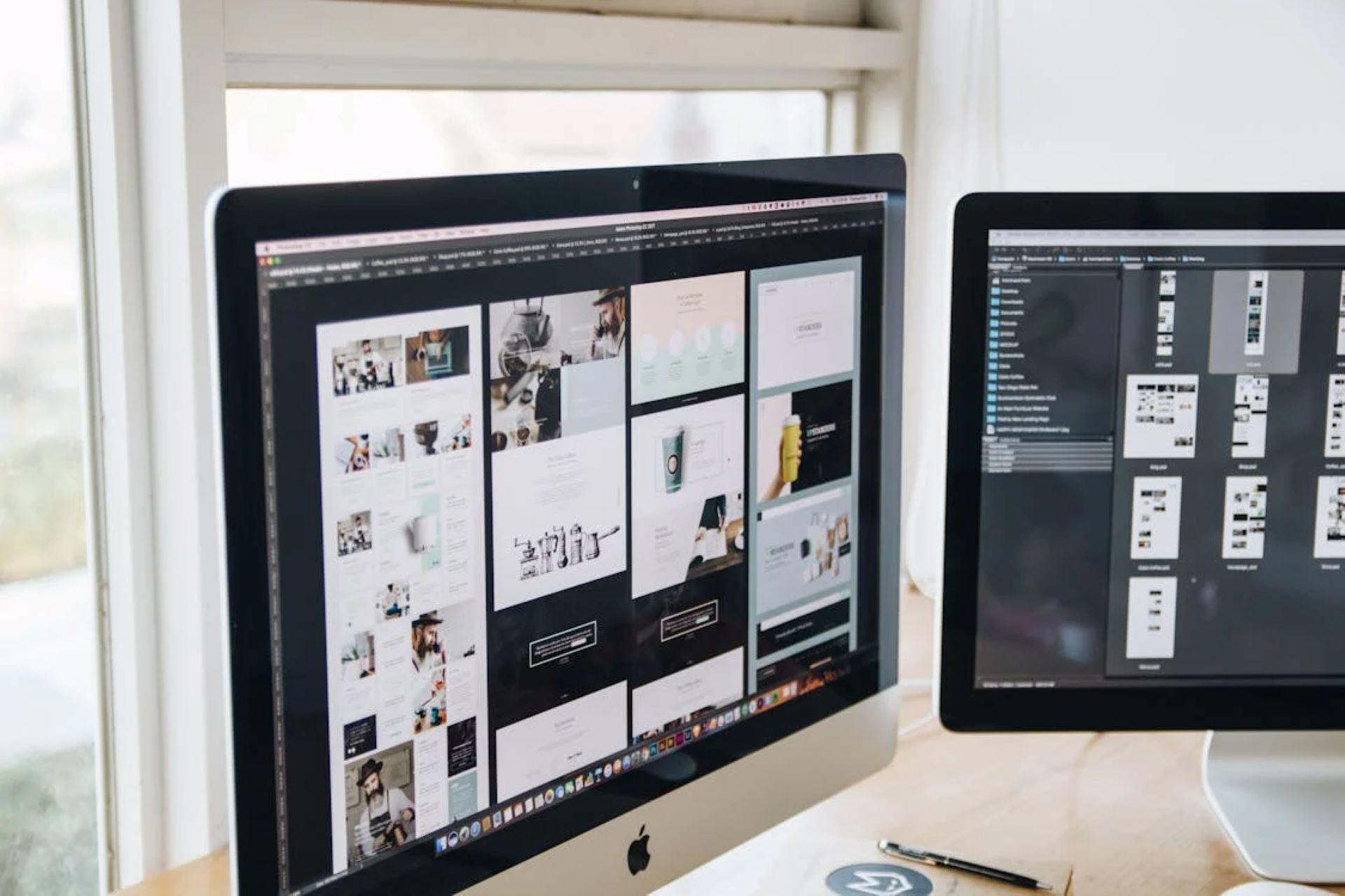 Two computer monitors displaying different websites