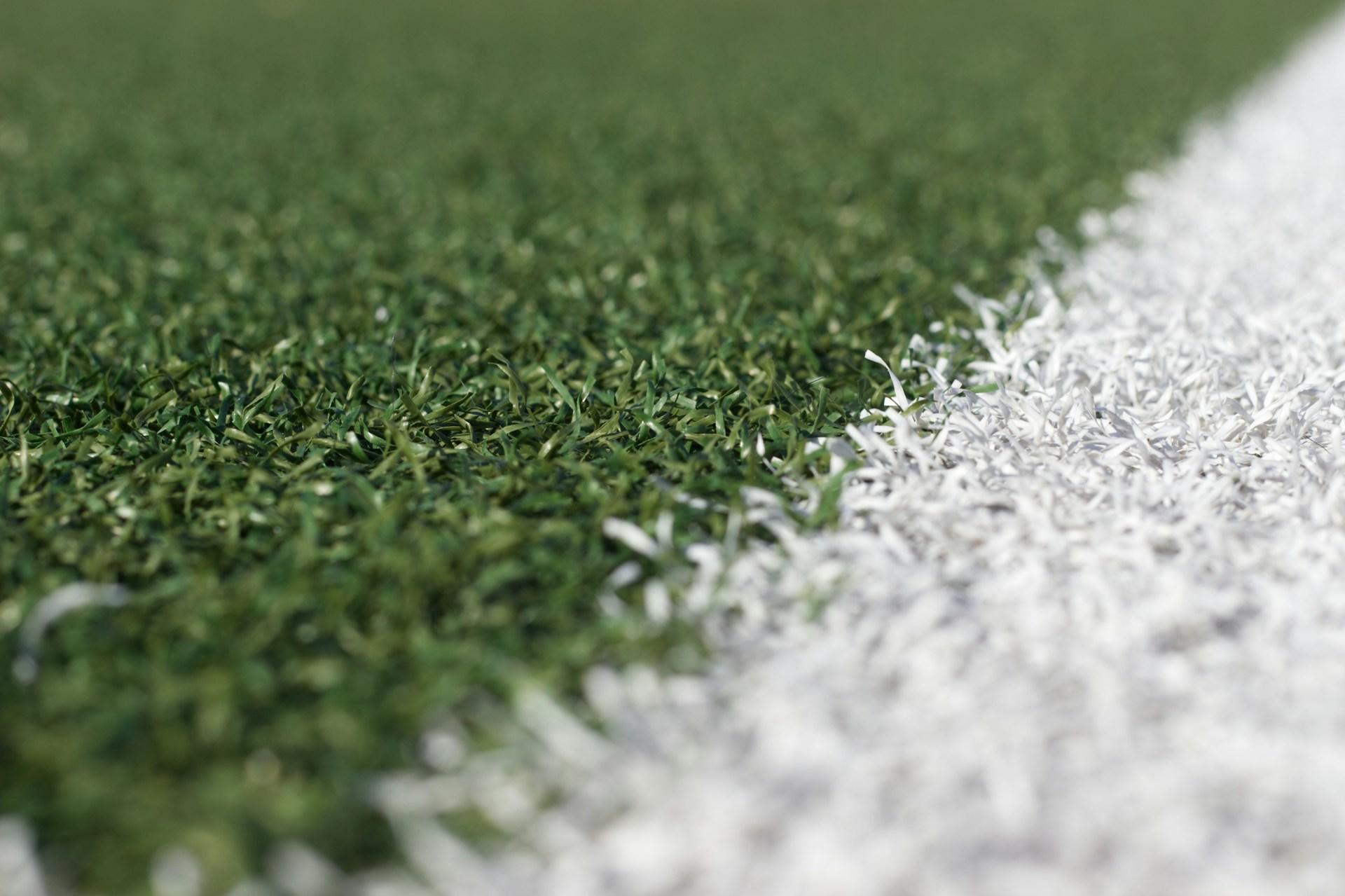 A closeup of a line on a football pitch.