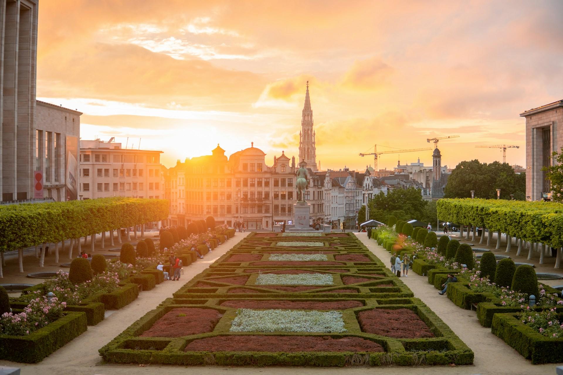 A view of a sunset over some gardens in Brussels.
