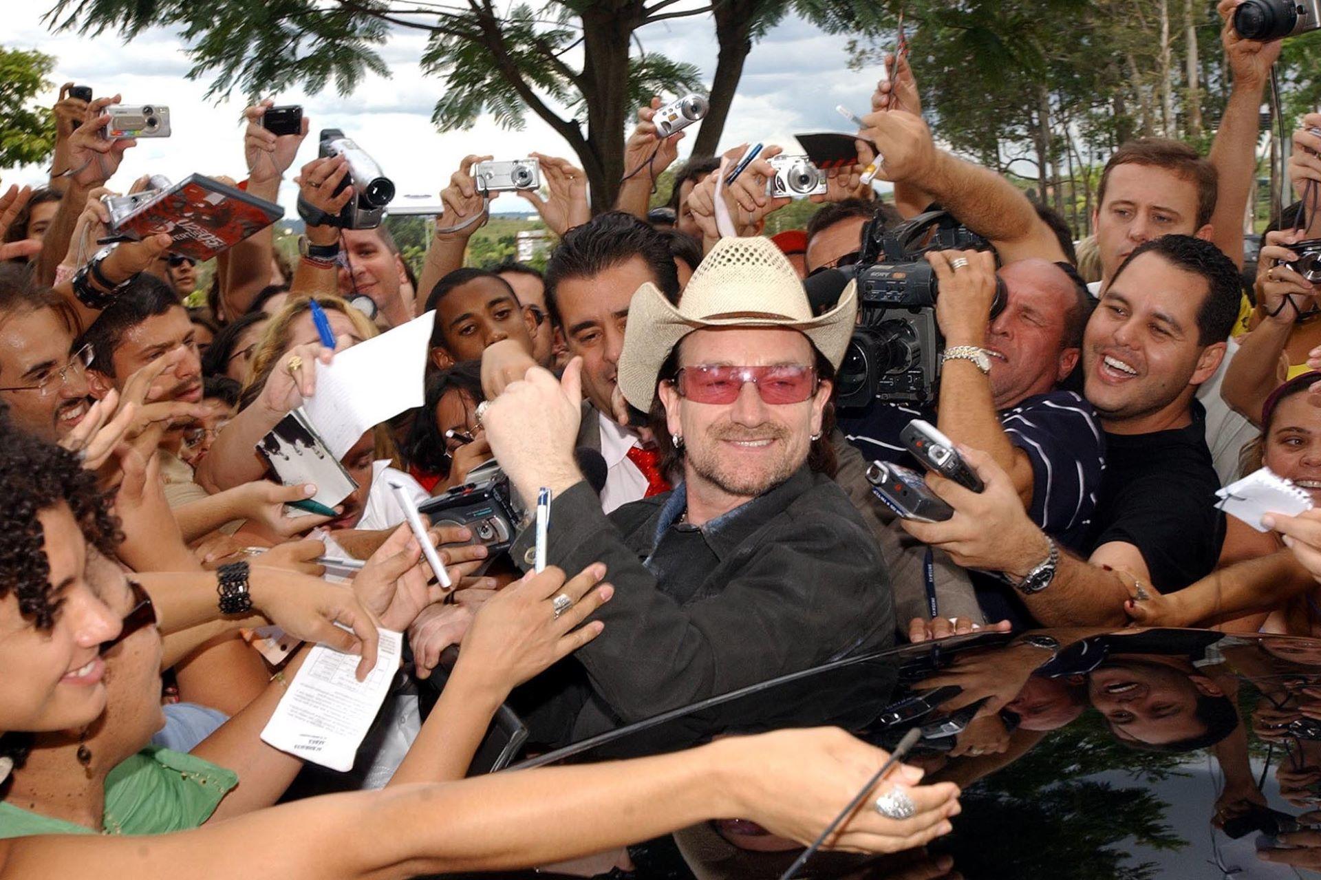 Bono surrounded by fans in Brazil.