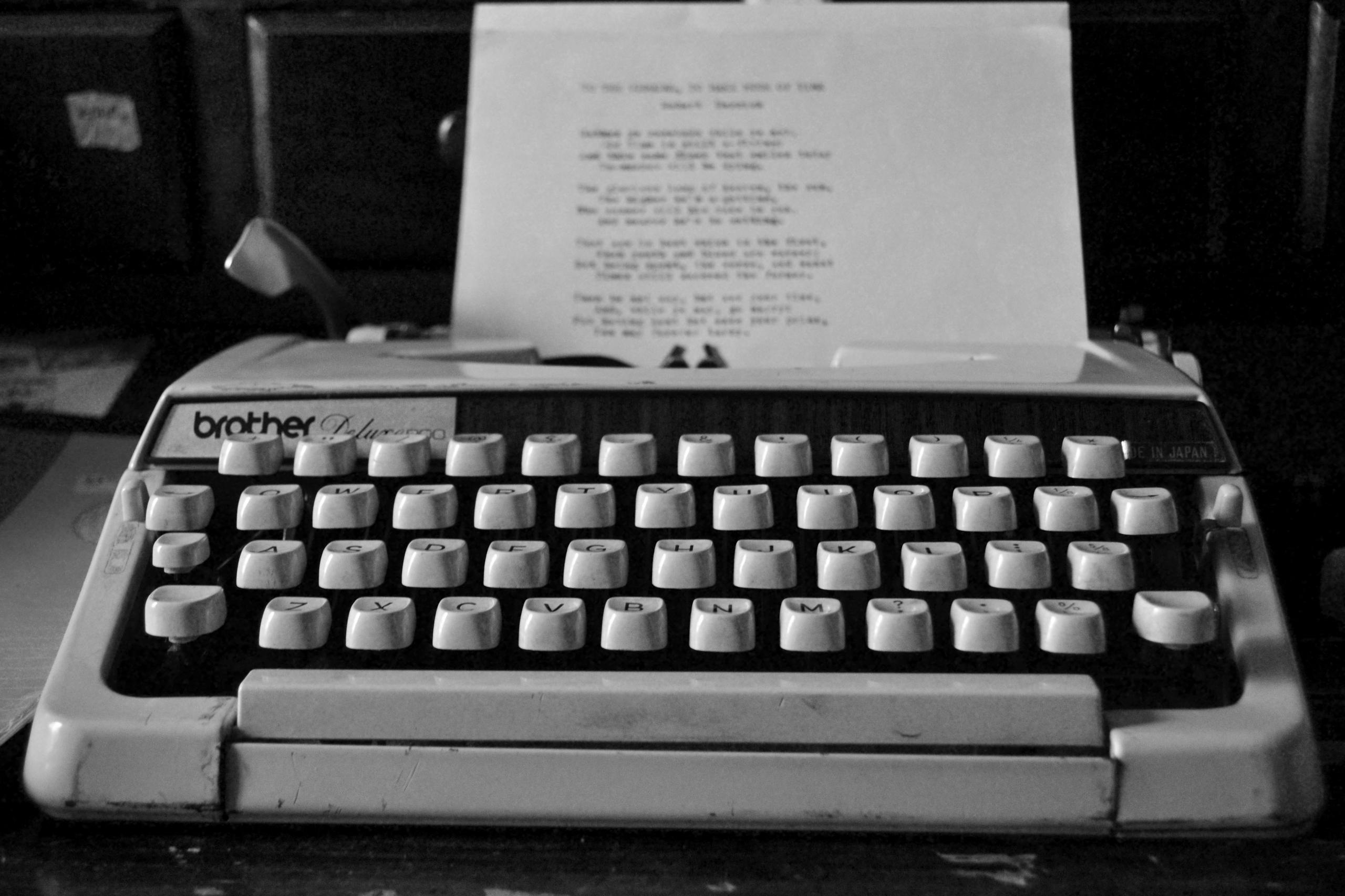 A cover letter is being drafted on an old typewriter.