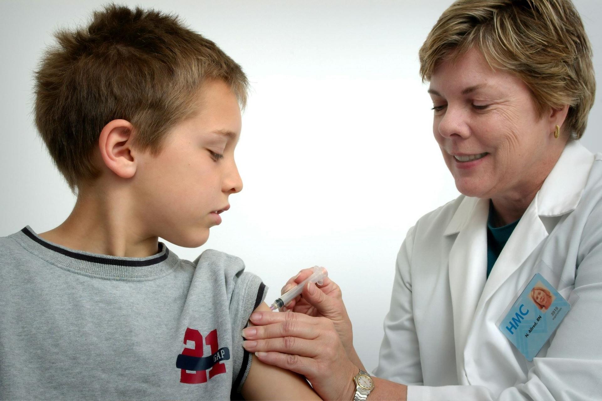 A doctor giving a child a vaccination.
