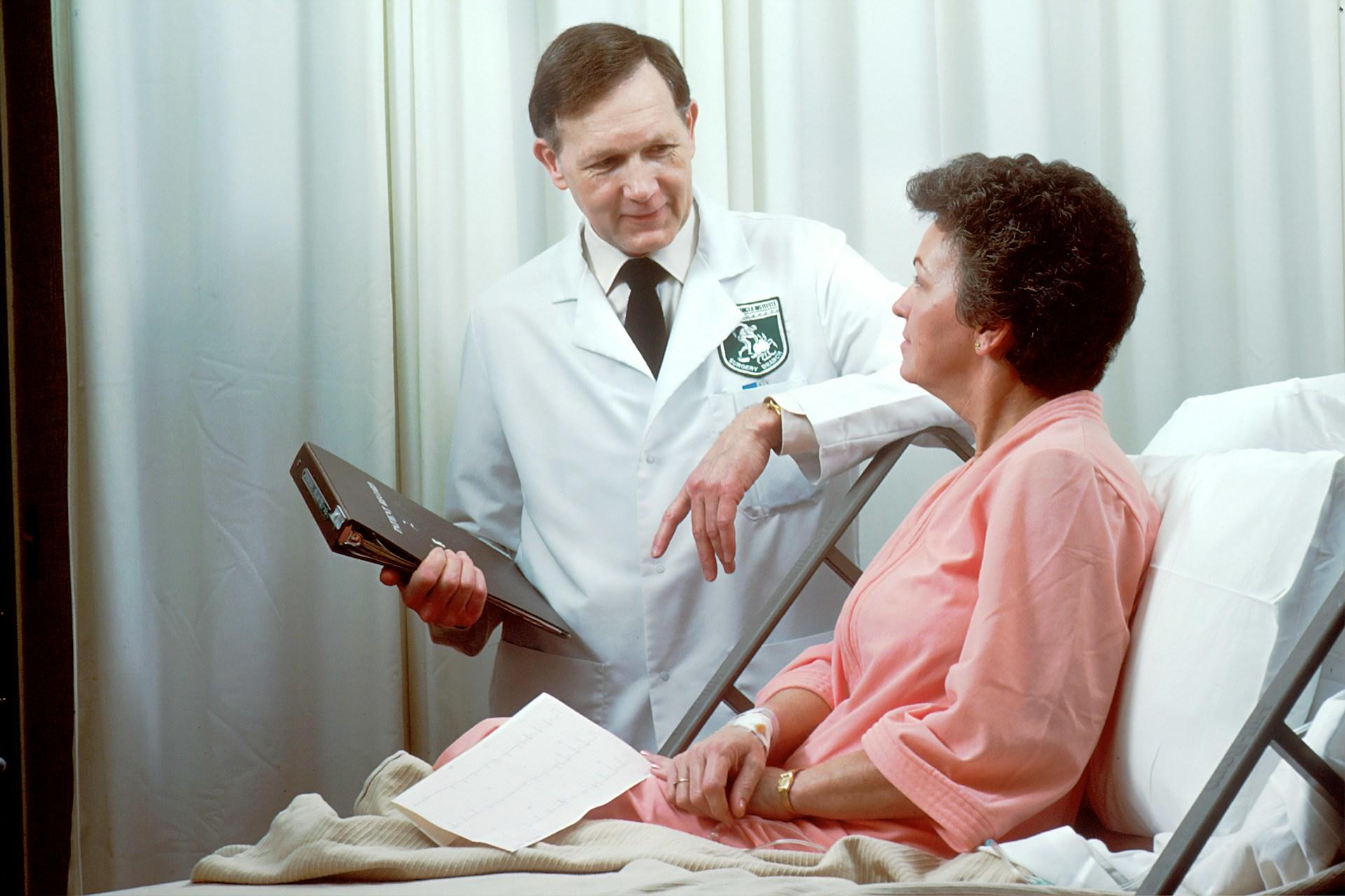 A doctor with a patient in bed.