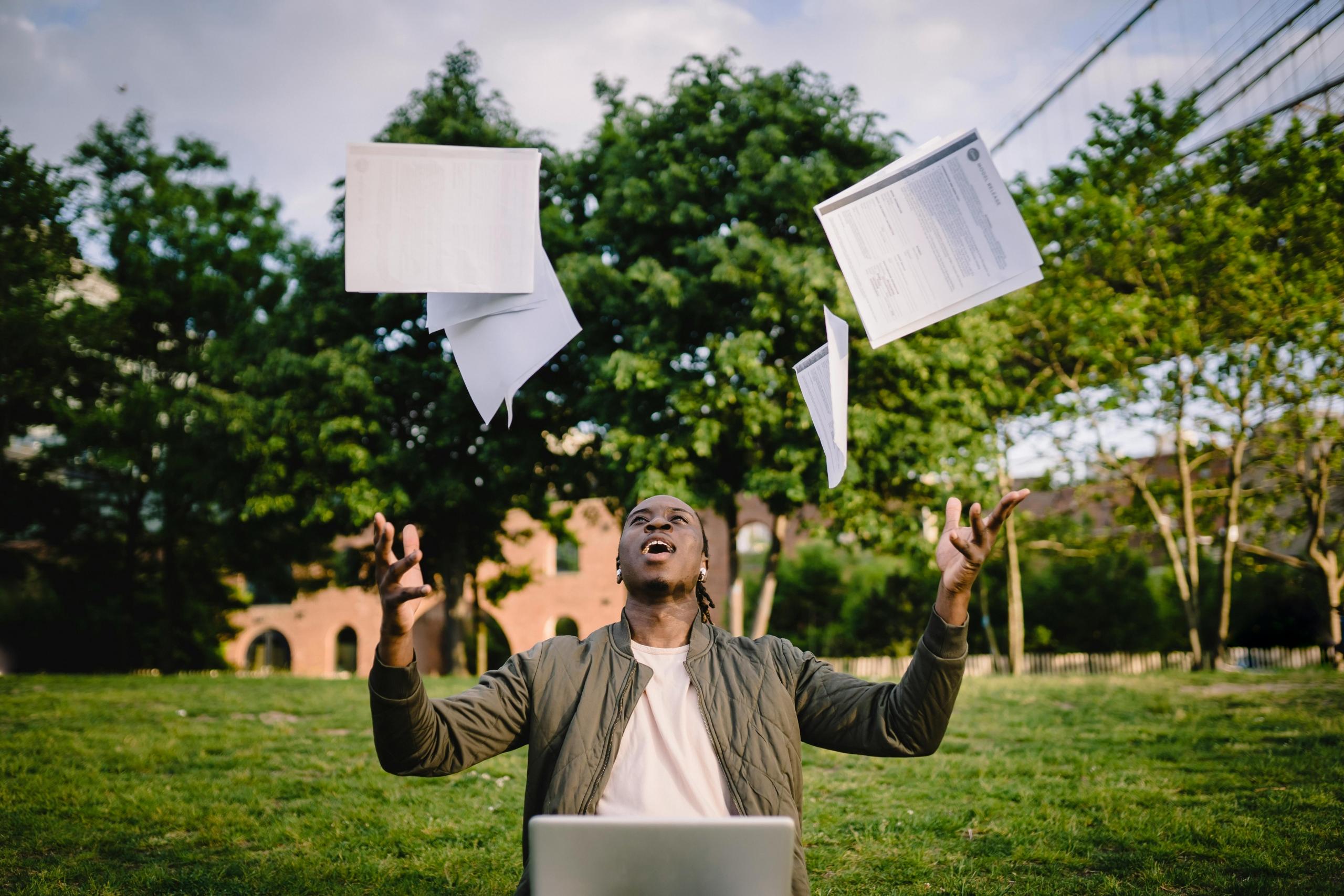 A student throwing away his notes in delight after acing his Irish Leaving Cert paper