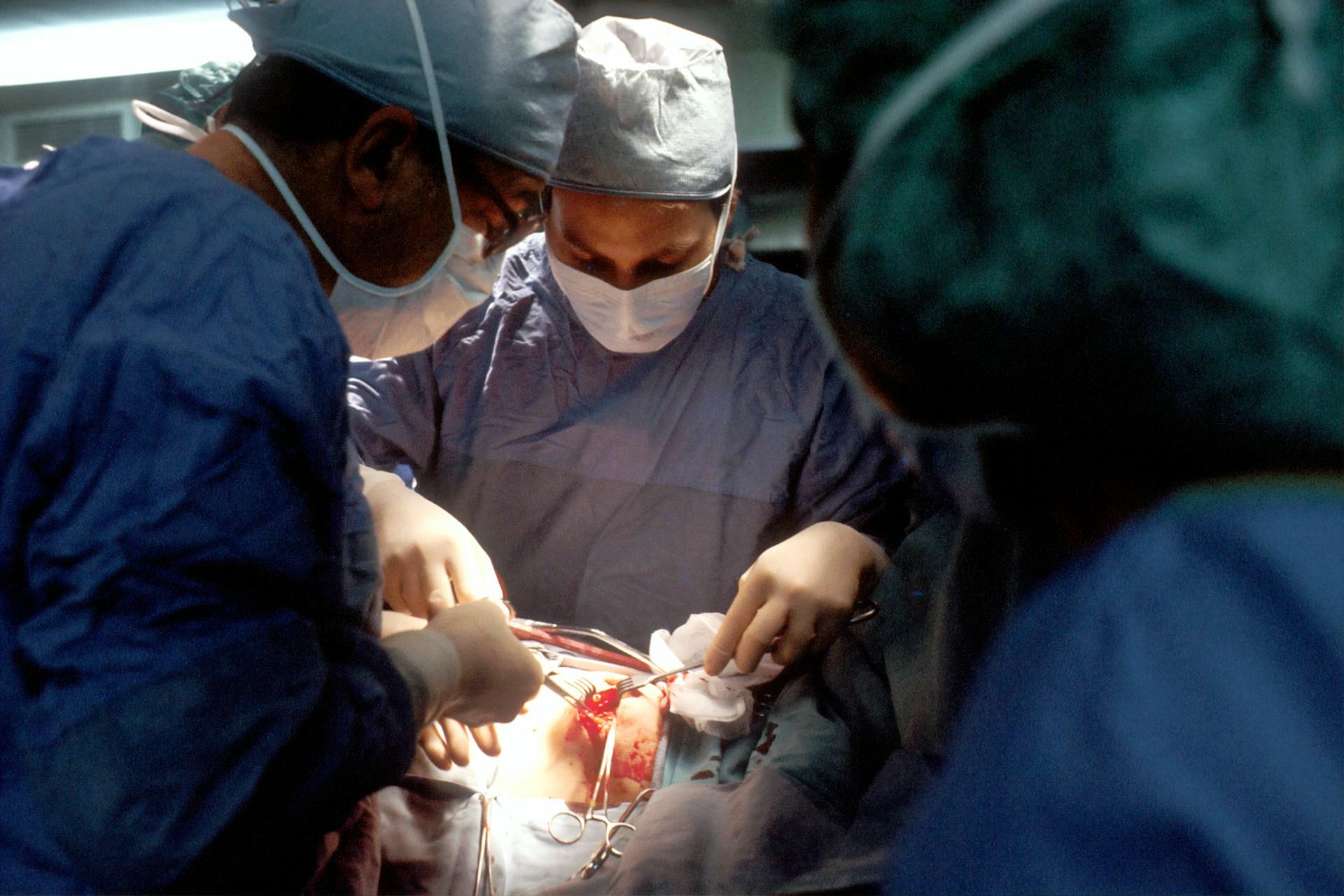 Several surgeons performing surgery.