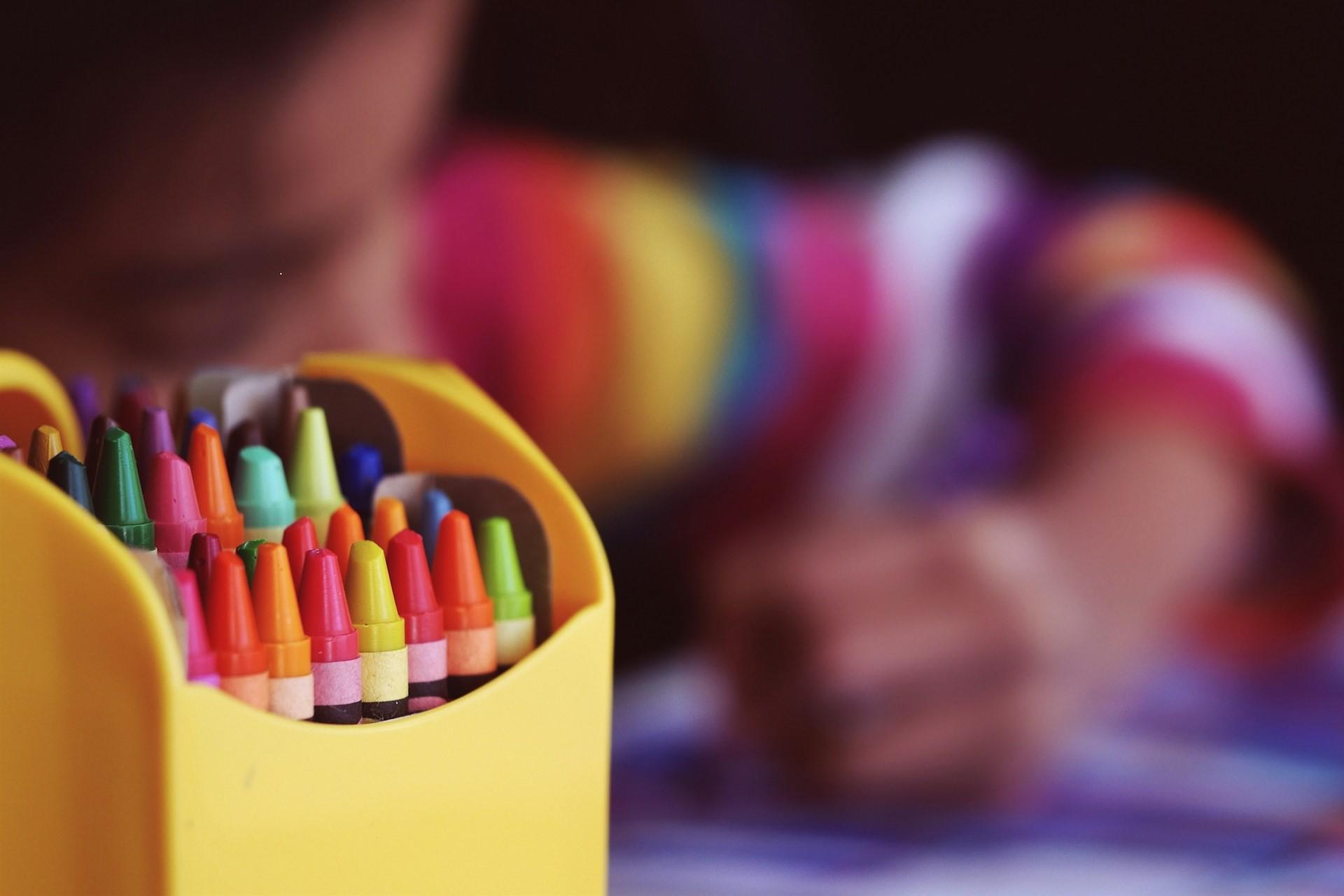 A child drawing with crayons.
