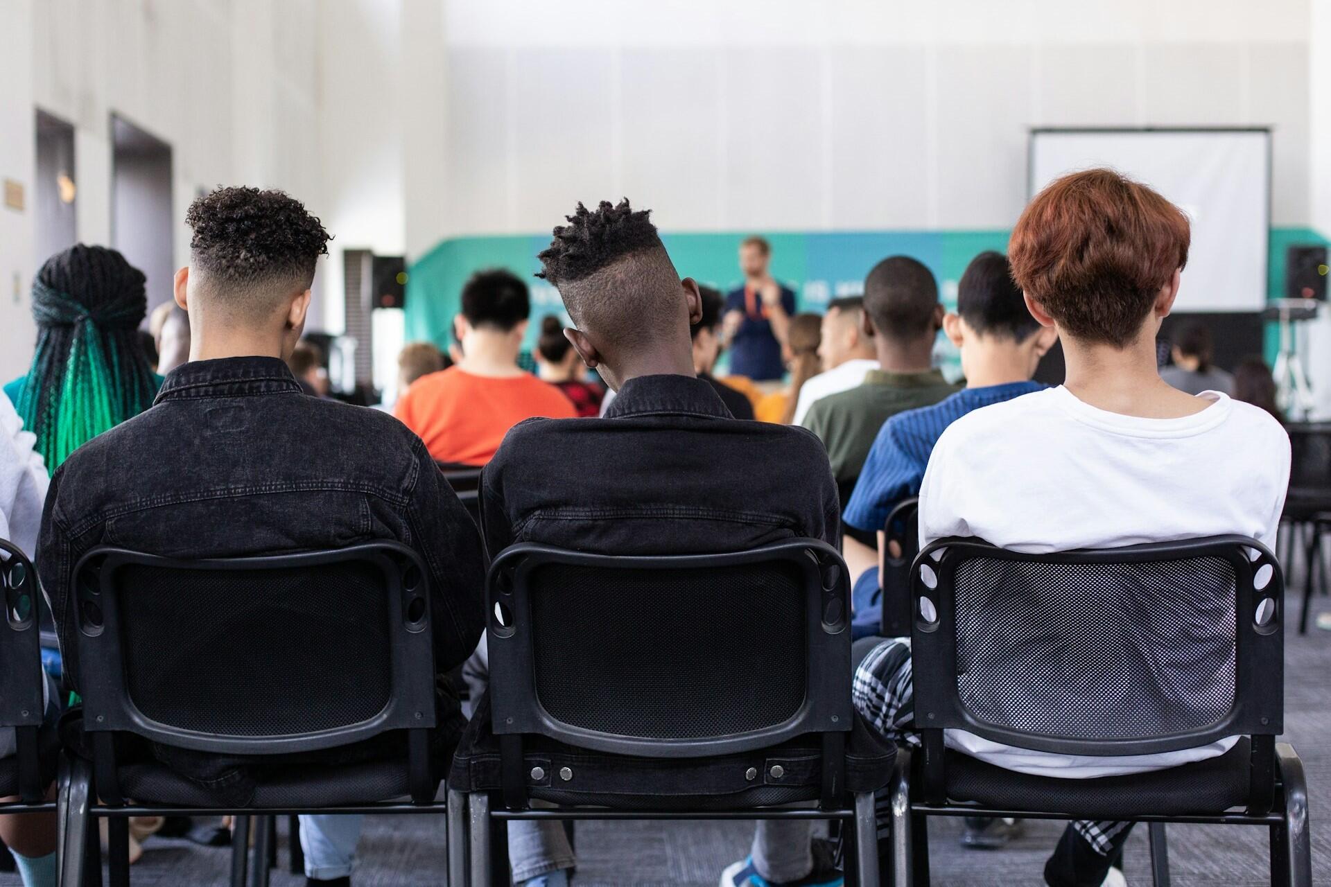 Students listening in a classroom.