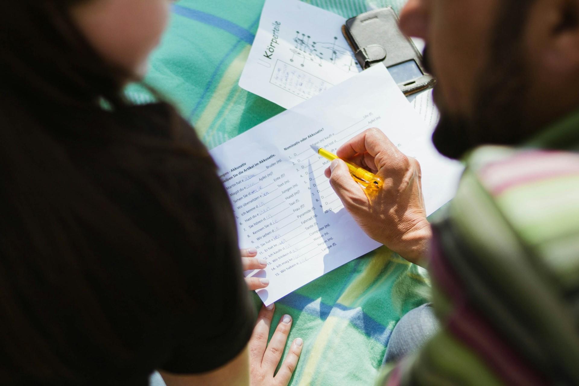 A teacher or tutor working with a student.