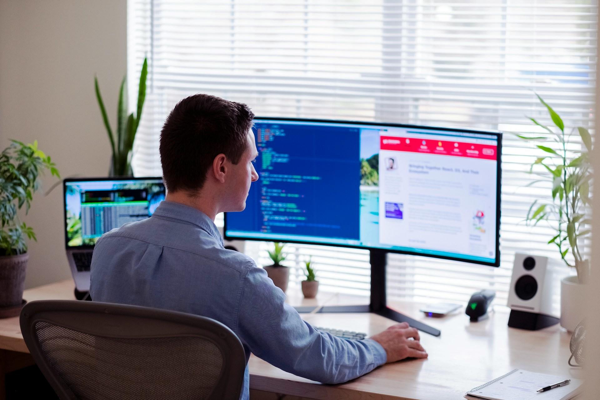 A person coding in a home office.