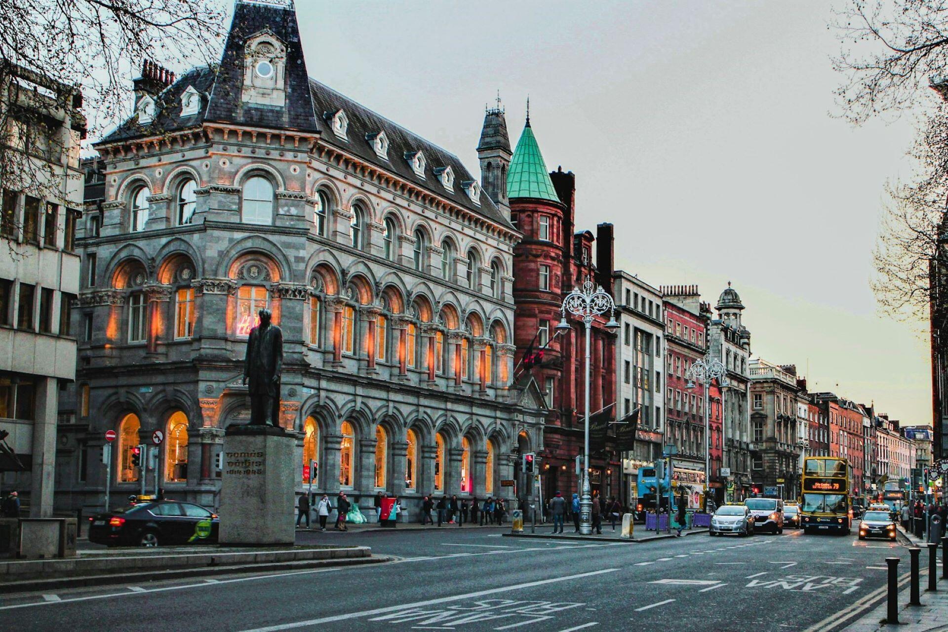 College Green in Dublin with historic buildings, traffic and pedestrians