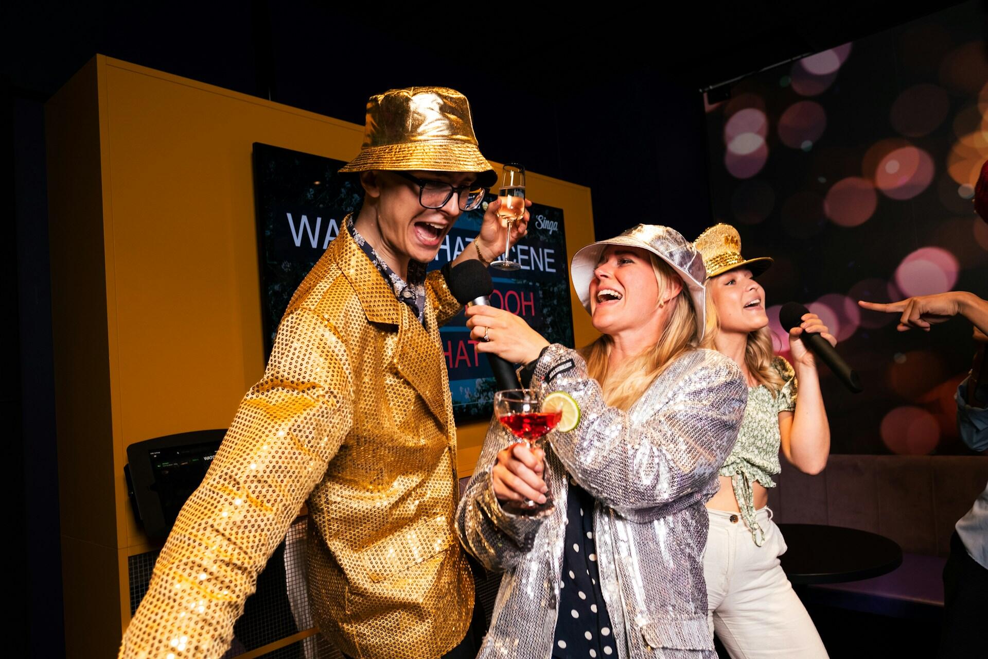 Some mates singing karaoke together.