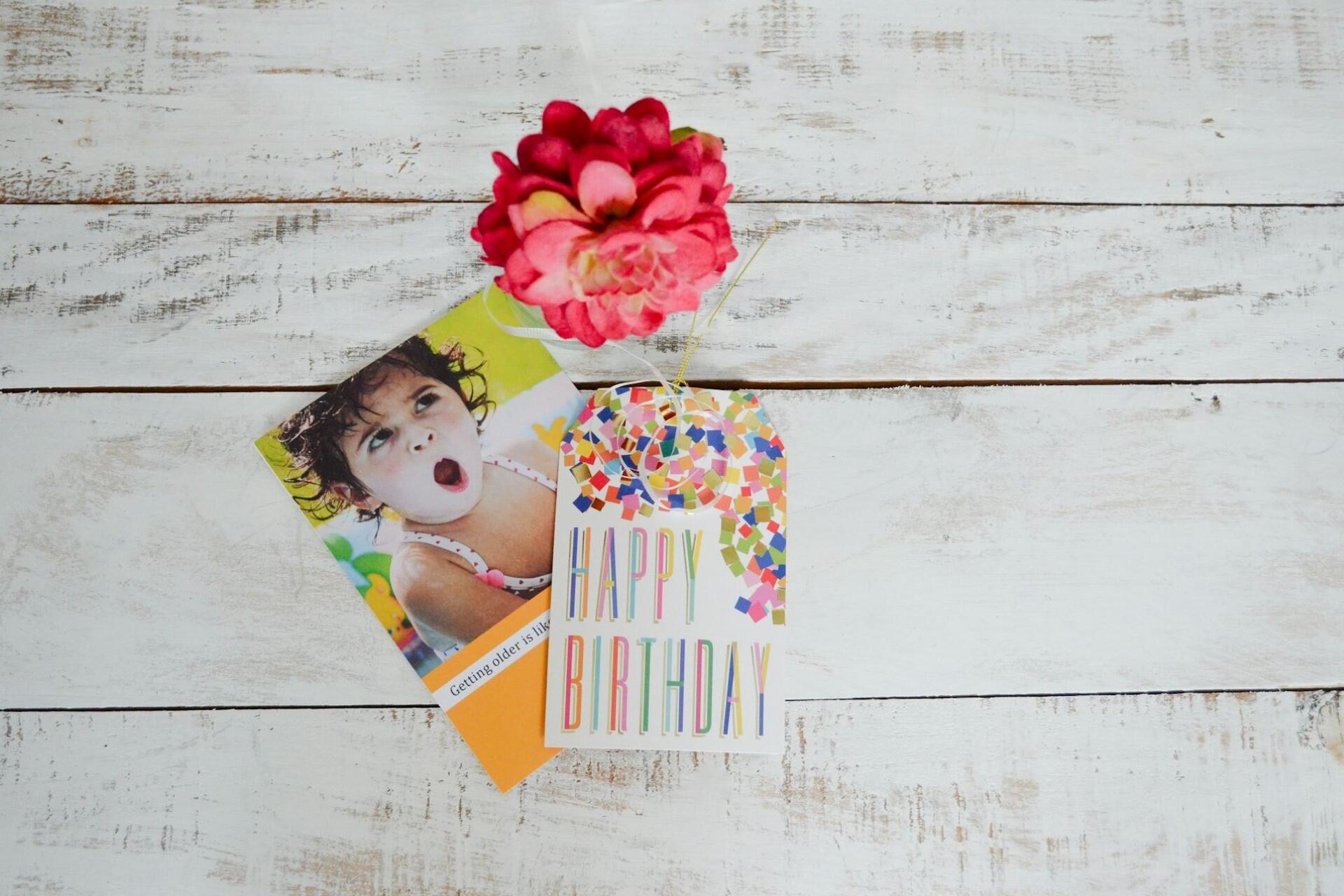 Birthday card and gift tag on a wooden surface