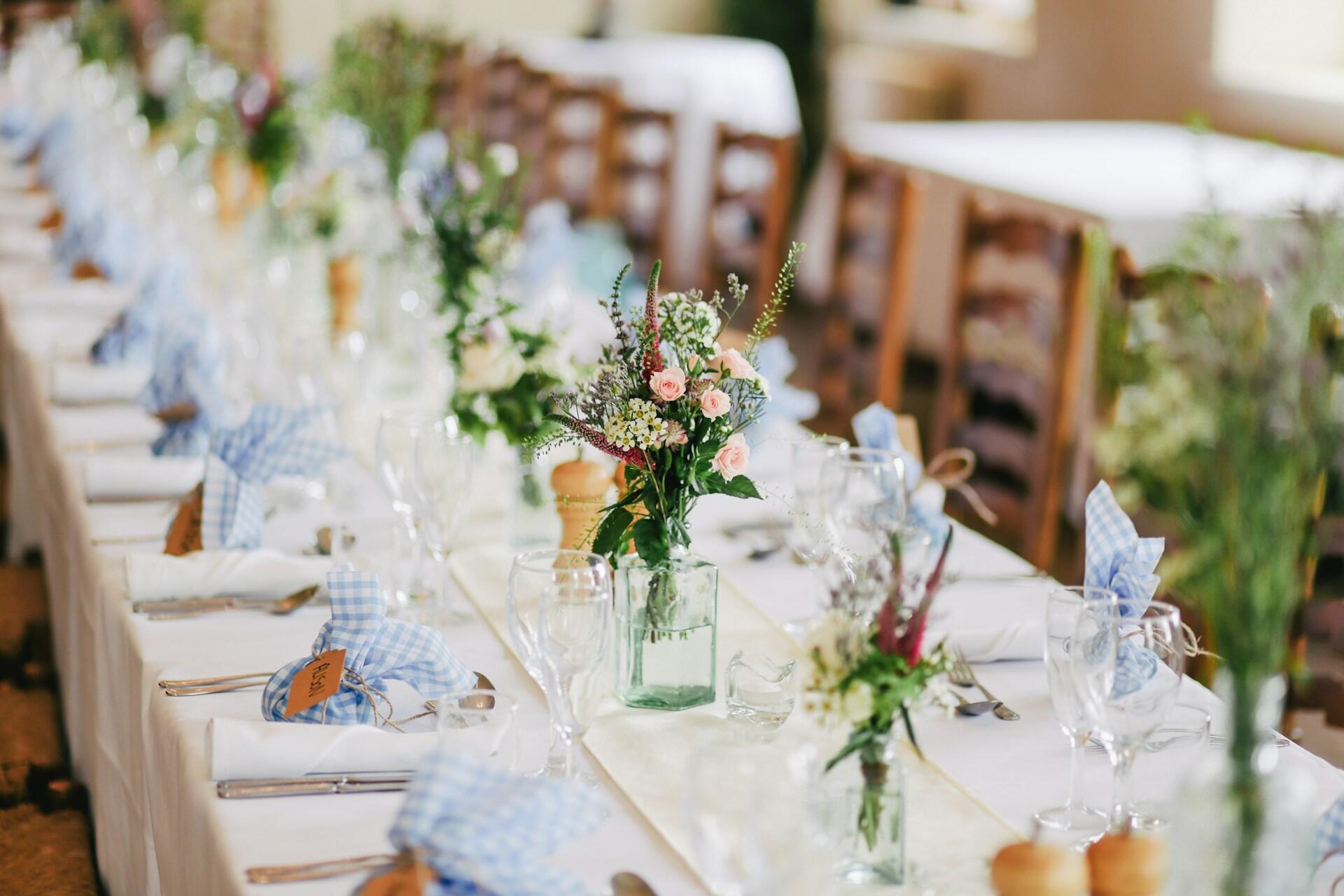 decorated table with flowers and place settings for a celebration