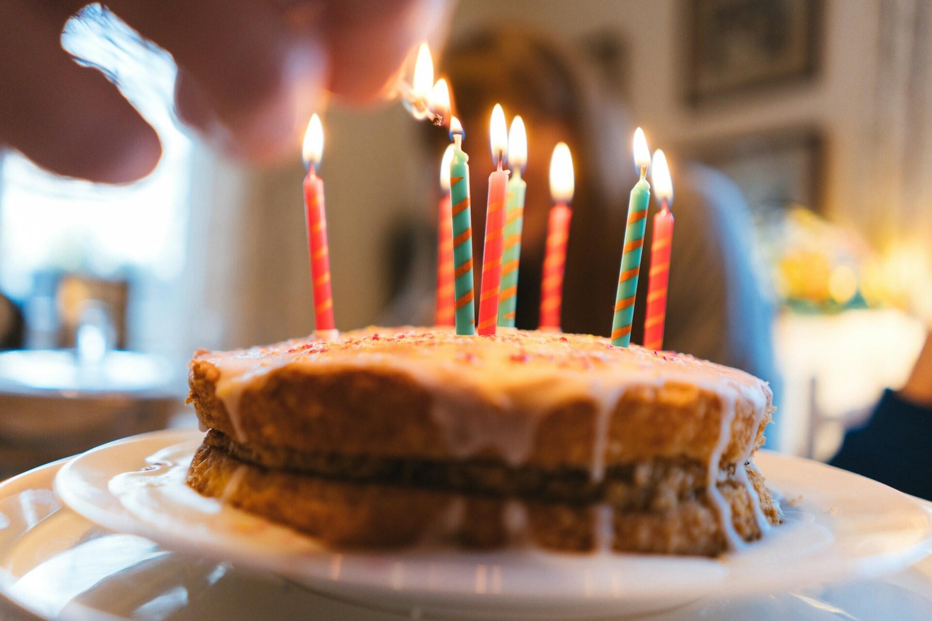 Lit birthday candles on a cake with icing