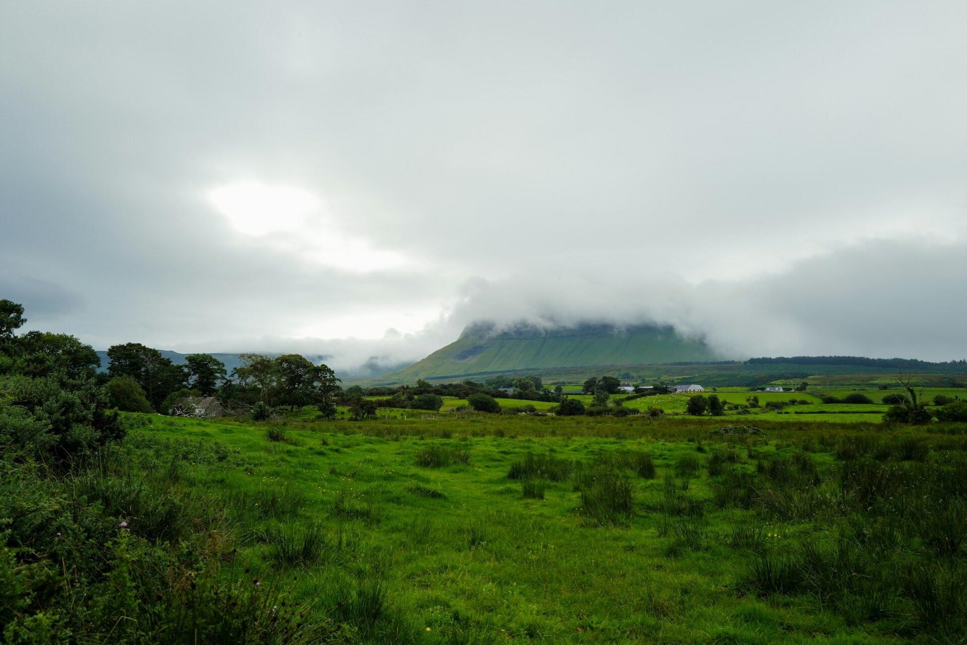 green Irish countryside with hills and mist