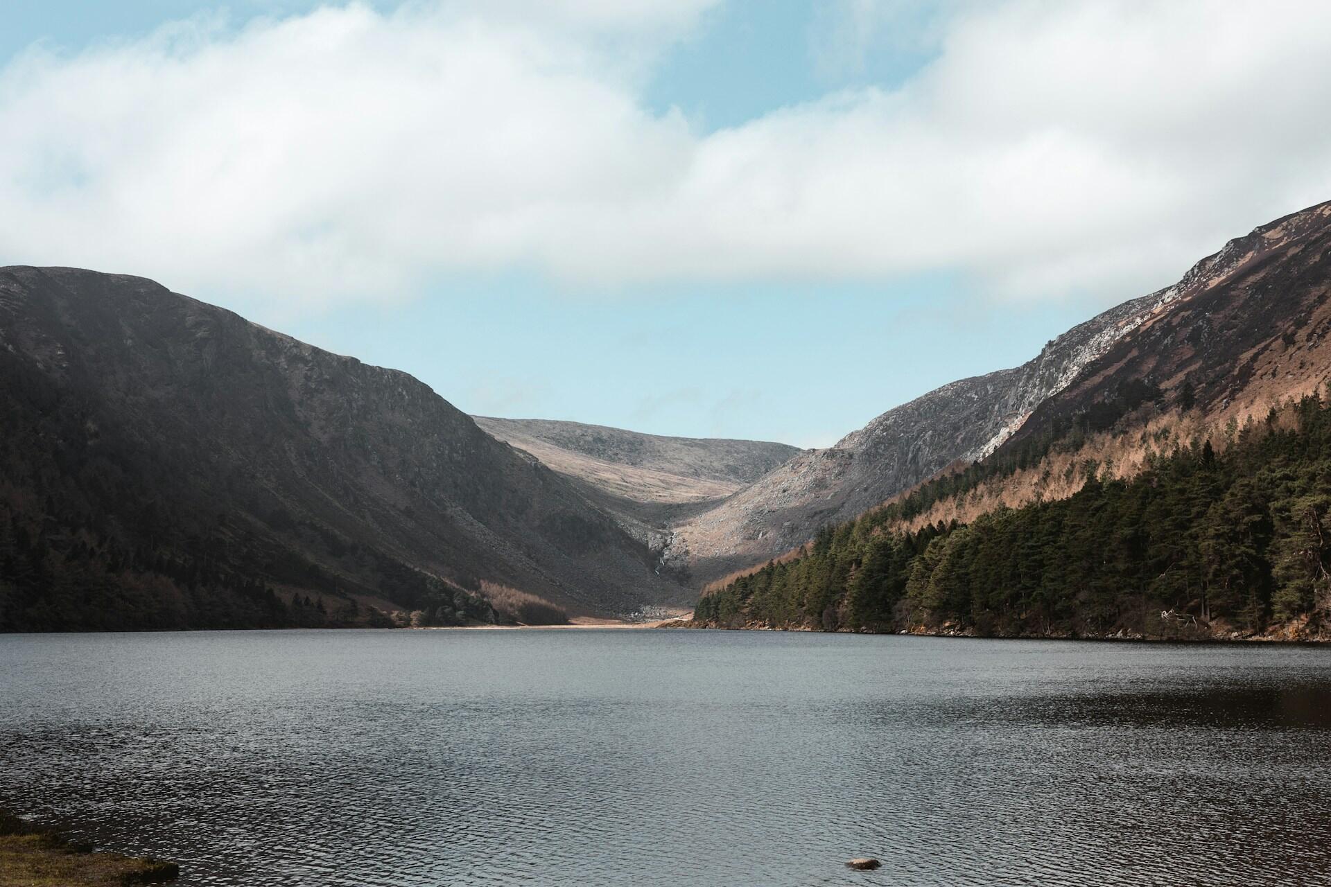 mountain lake surrounded by hills and trees