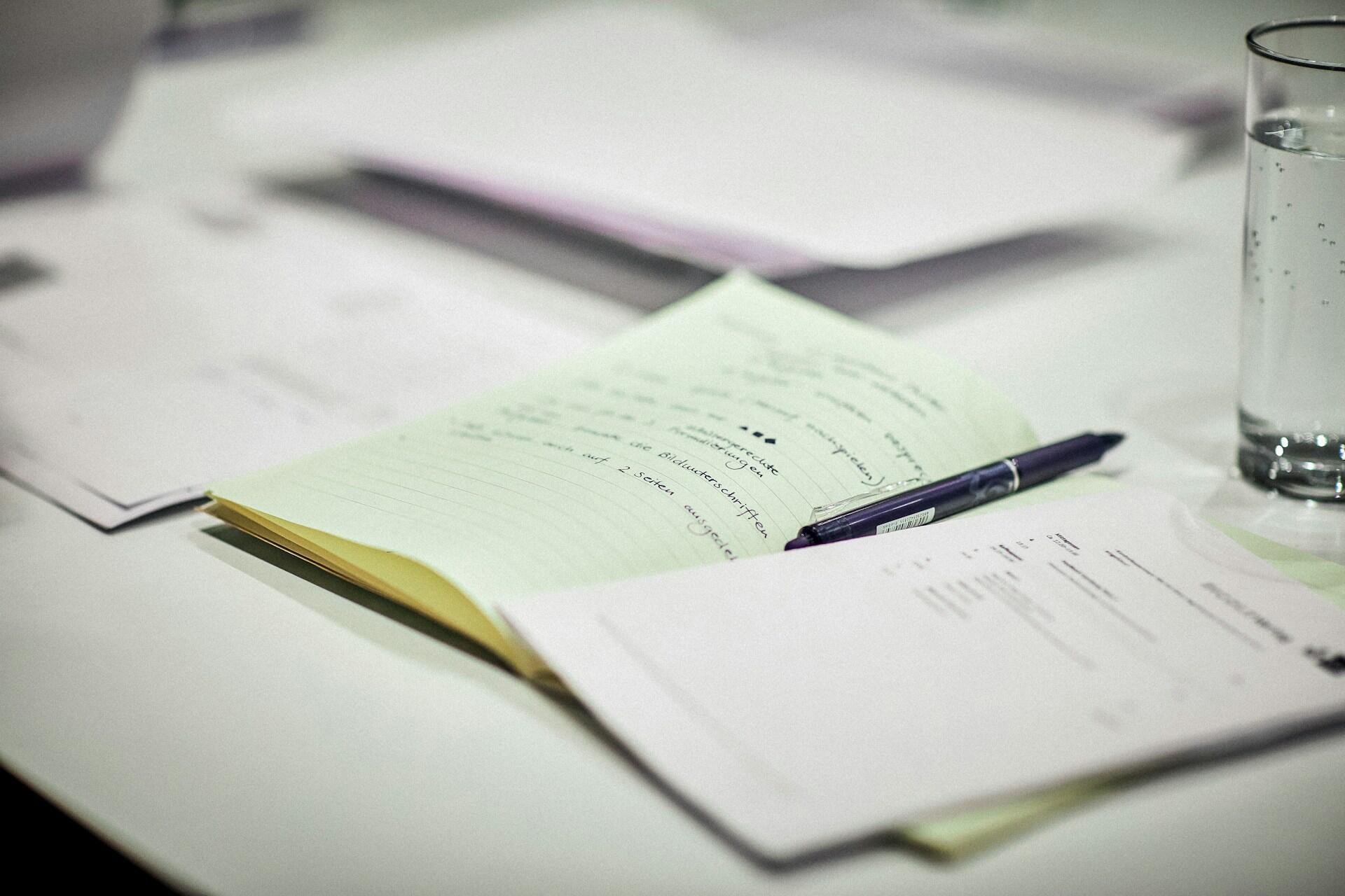 Notebook with handwritten notes and pen on a desk