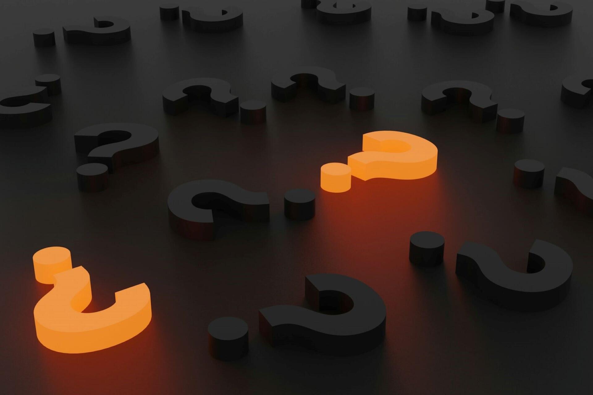 glowing question marks on dark background