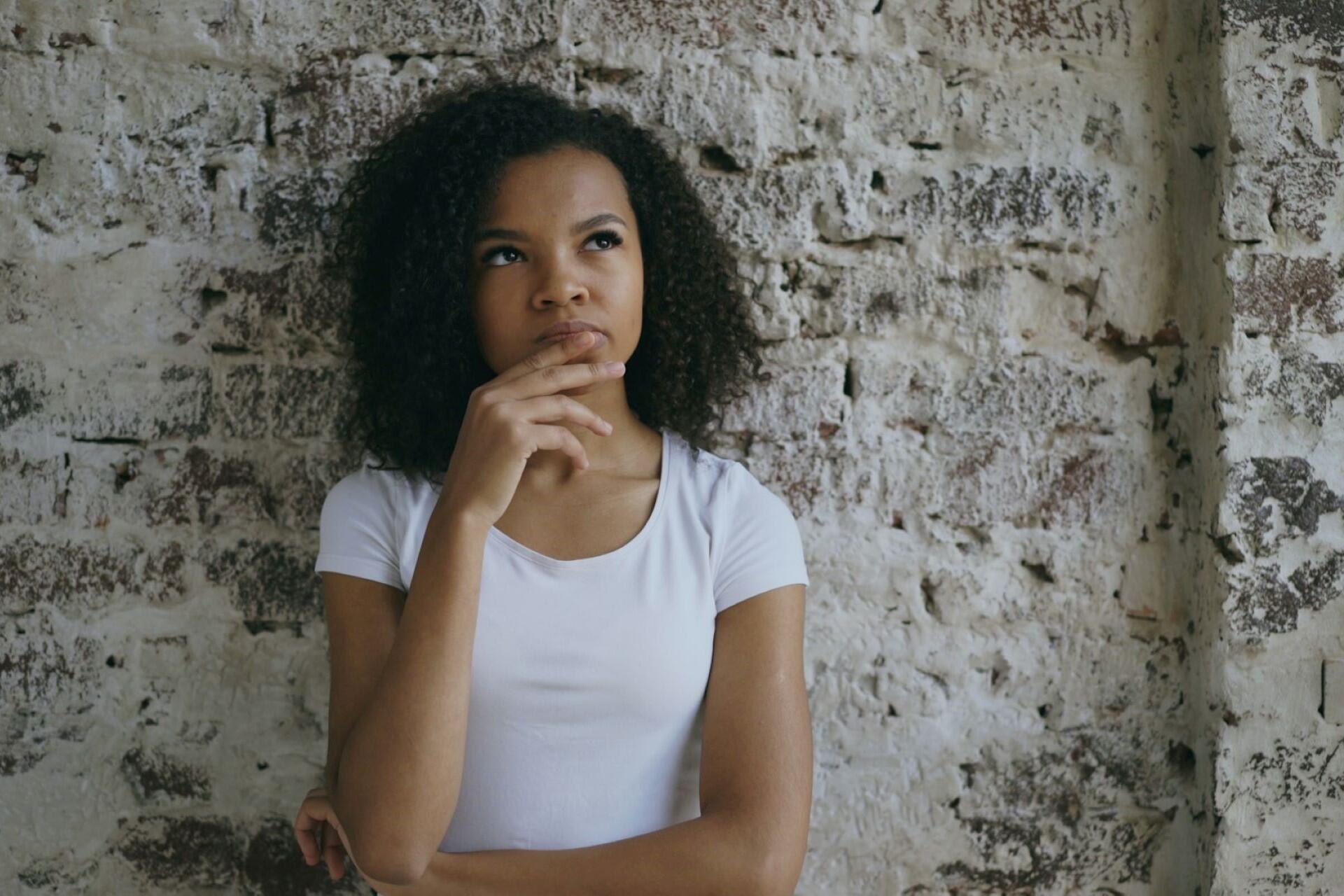 woman thinking with hand on chin