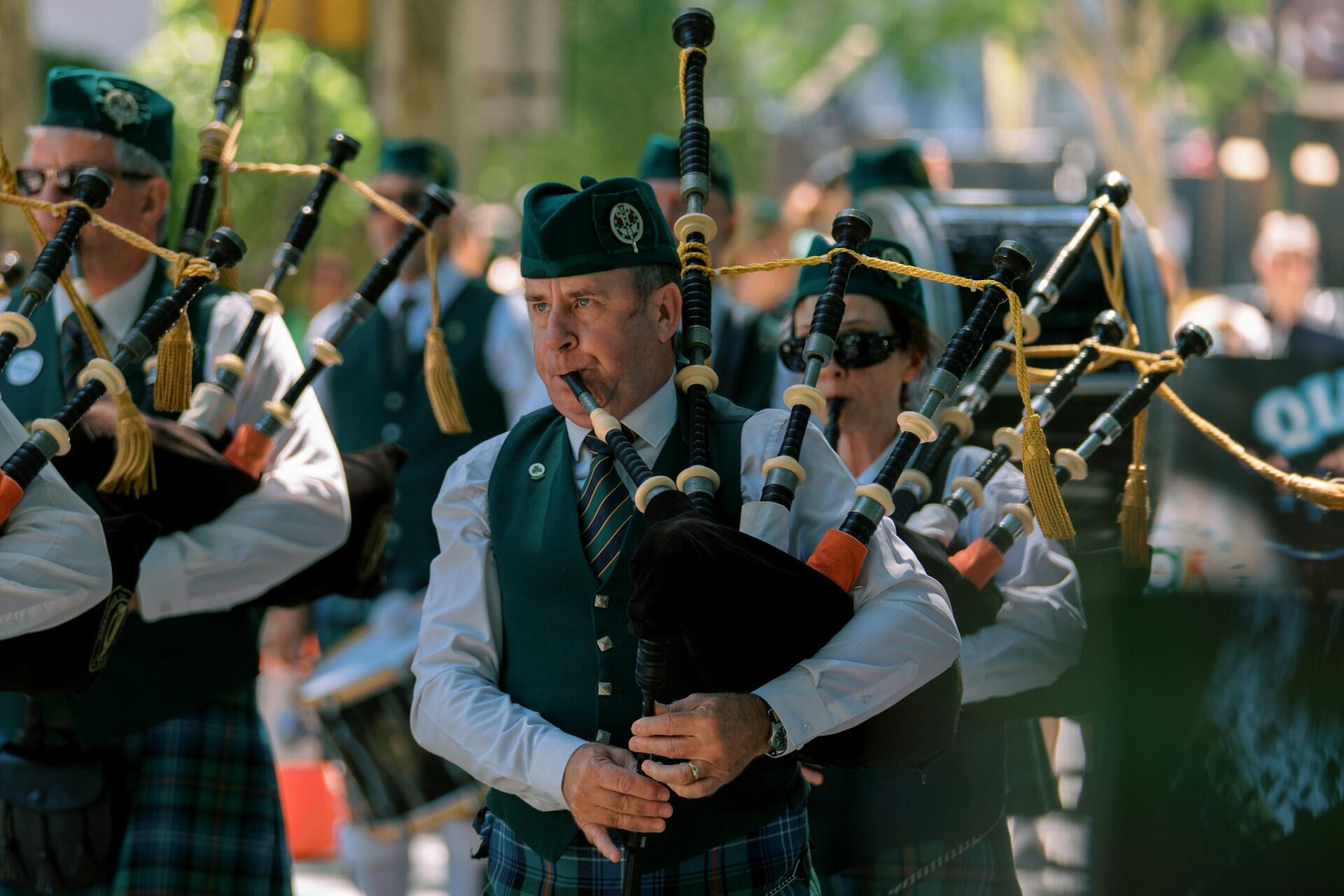group of musicians playing bagpipes during an Irish cultural parade