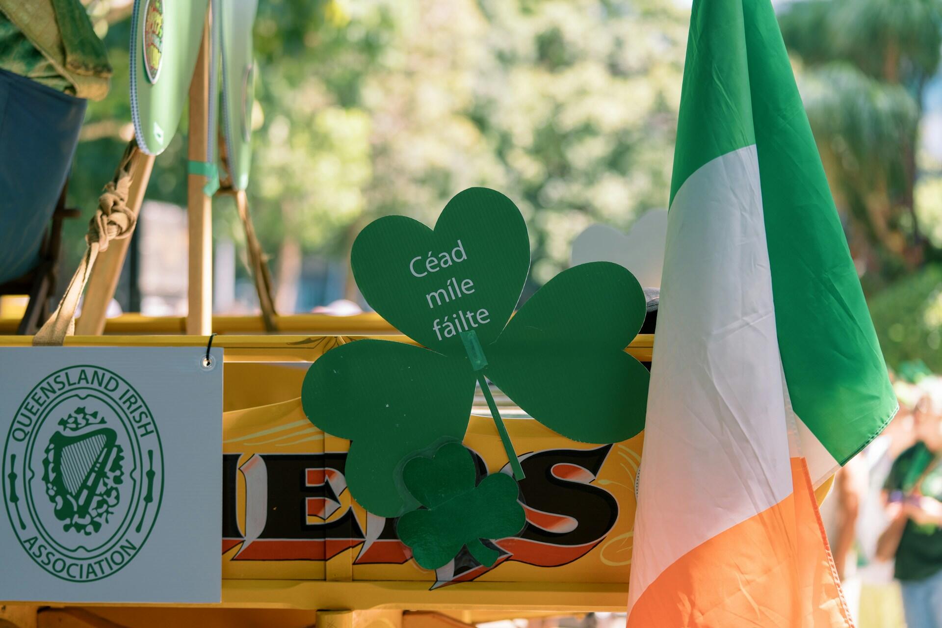 Irish flag and green shamrock decoration with the words Céad míle fáilte at a cultural event