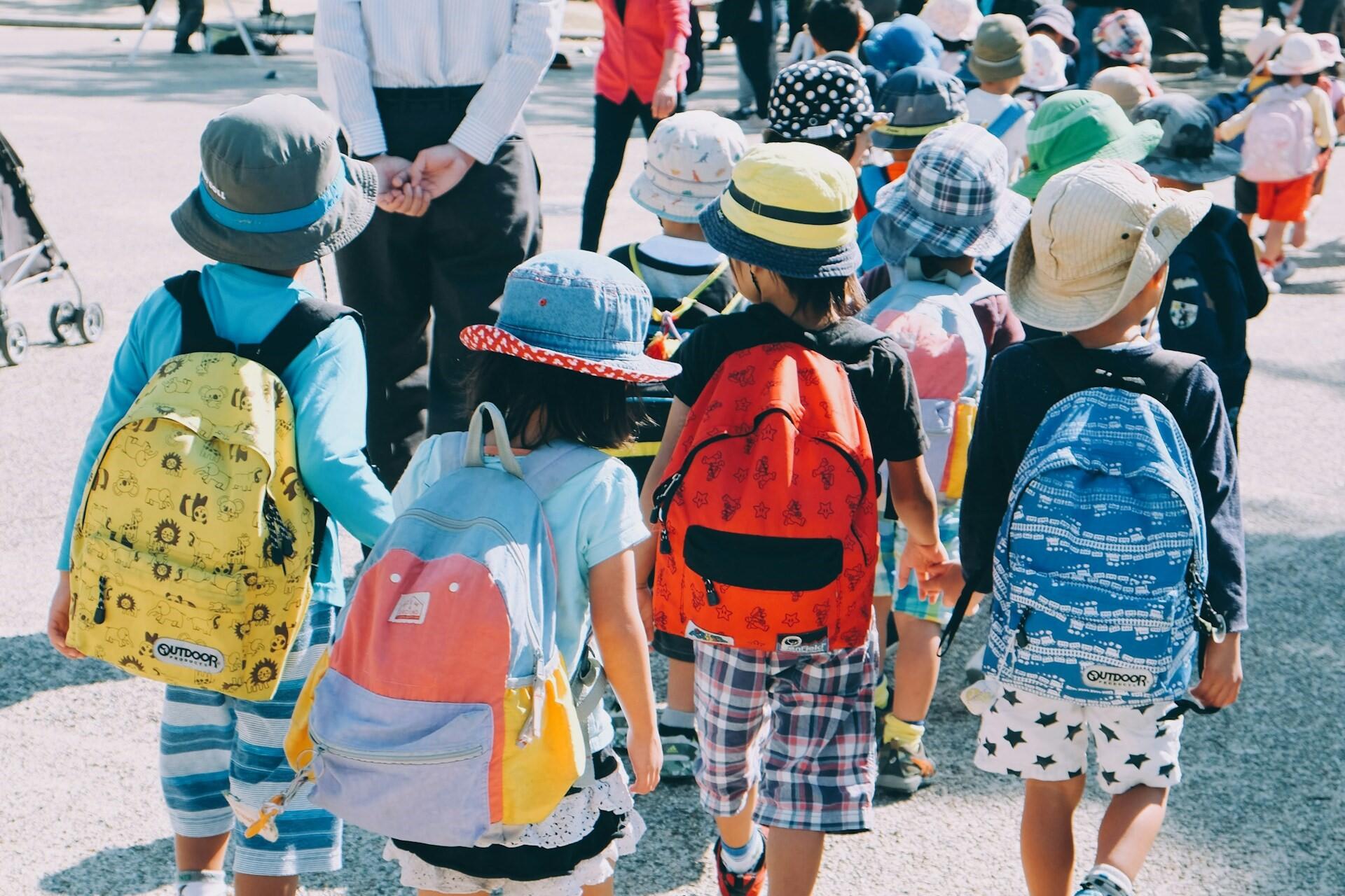 Group of children walking together with backpacks during a school outing