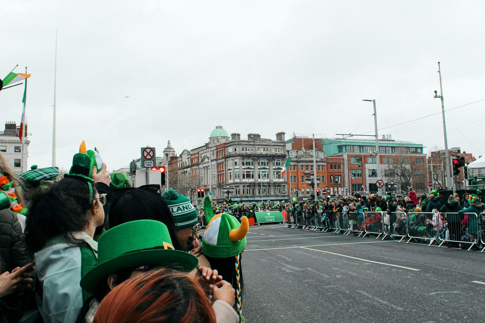 Crowds wearing green watching a St Patrick’s Day parade in Dublin