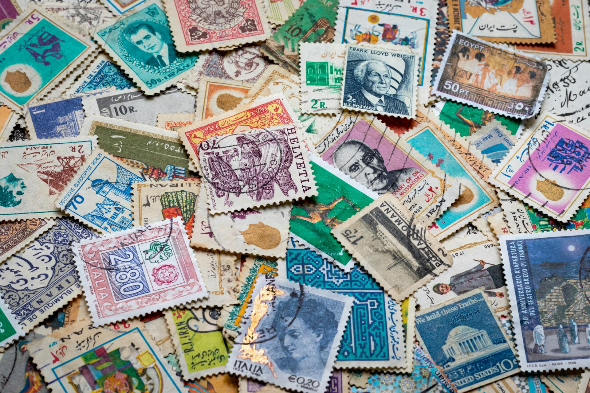 Collection of colourful vintage postage stamps from different countries.
