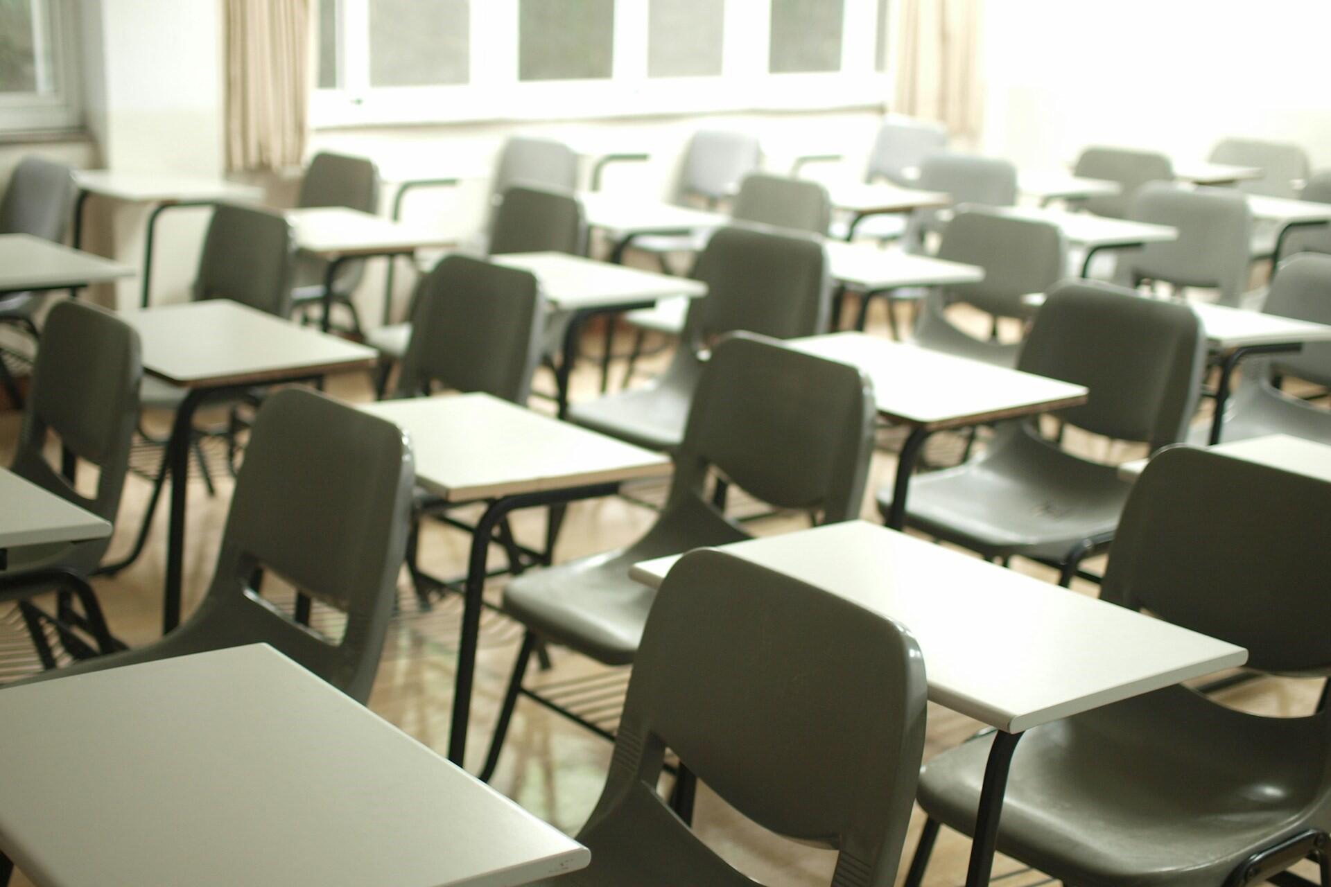 Empty classroom with desks and chairs arranged for students