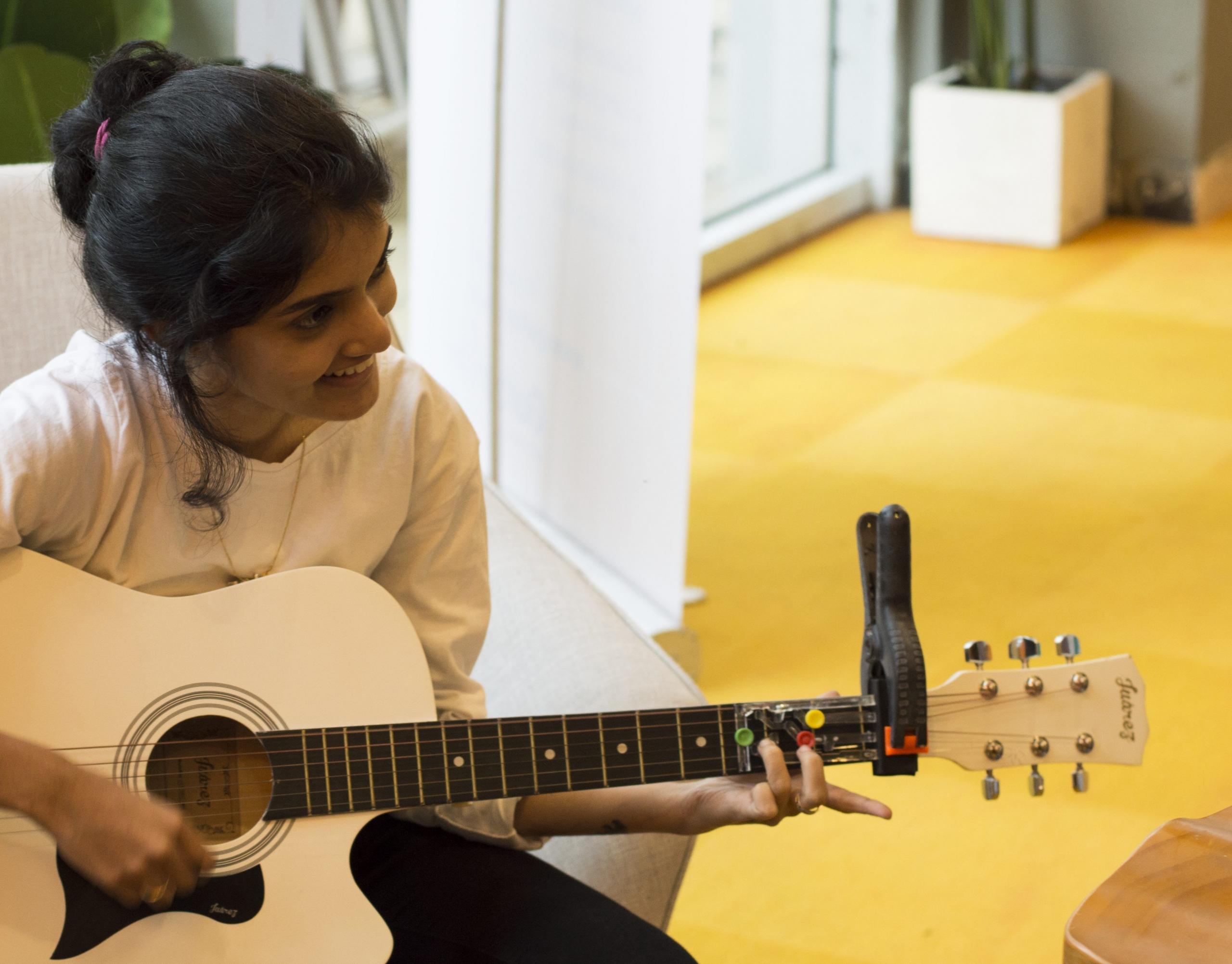 A girl posing with the guitar