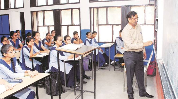 A teacher teaching students on black board