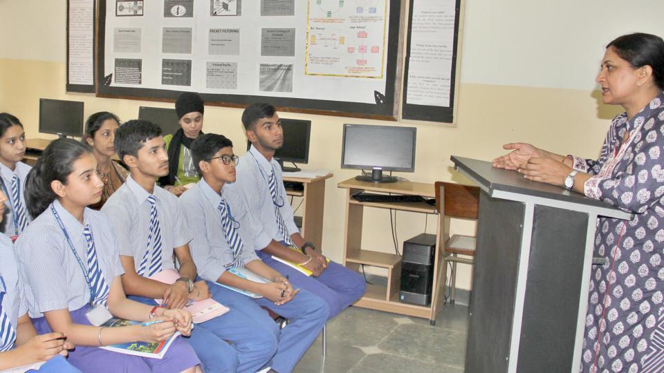 A teacher lecturing students in a classroom.