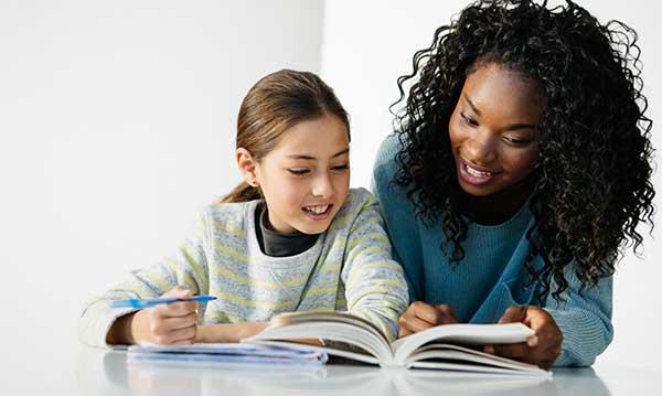 A teacher teaching her tutee.