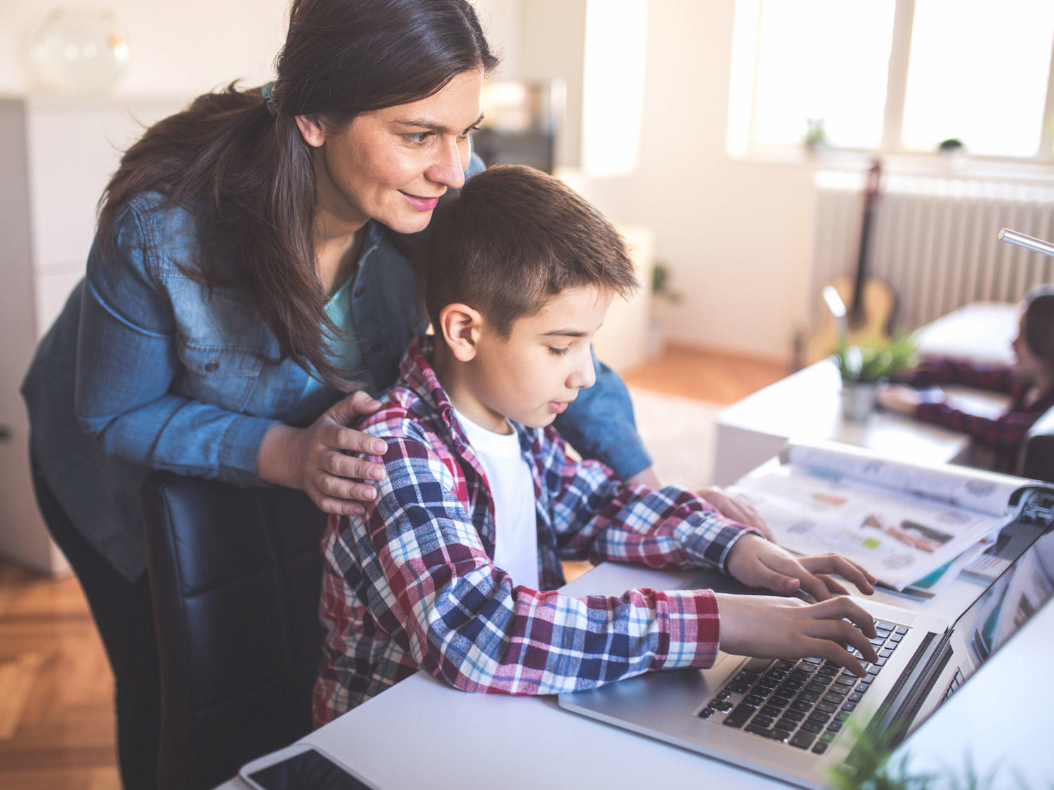 A teacher guiding her student