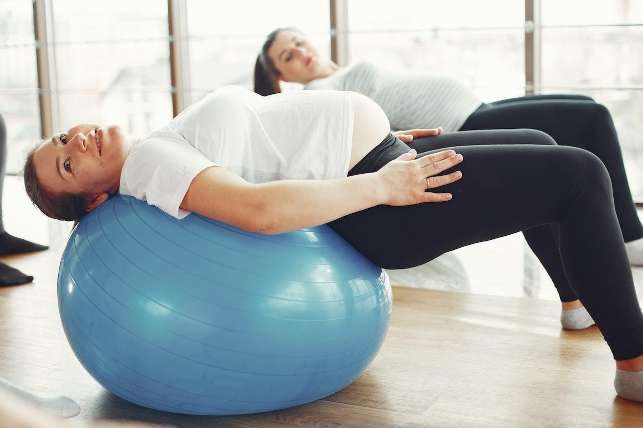 Pregnant yogis using exercise balls for prenatal yoga.