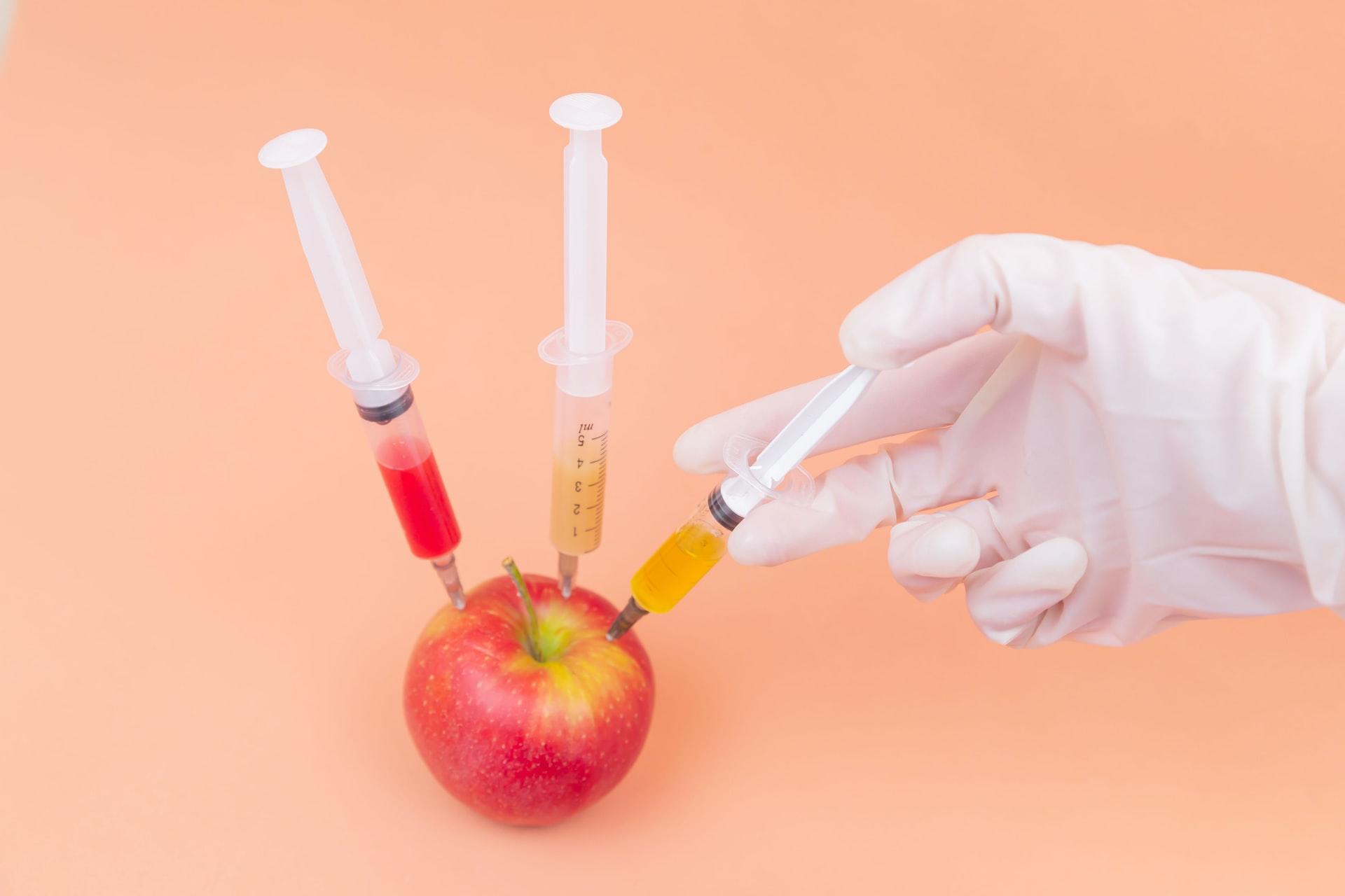 an apple with syringes in it