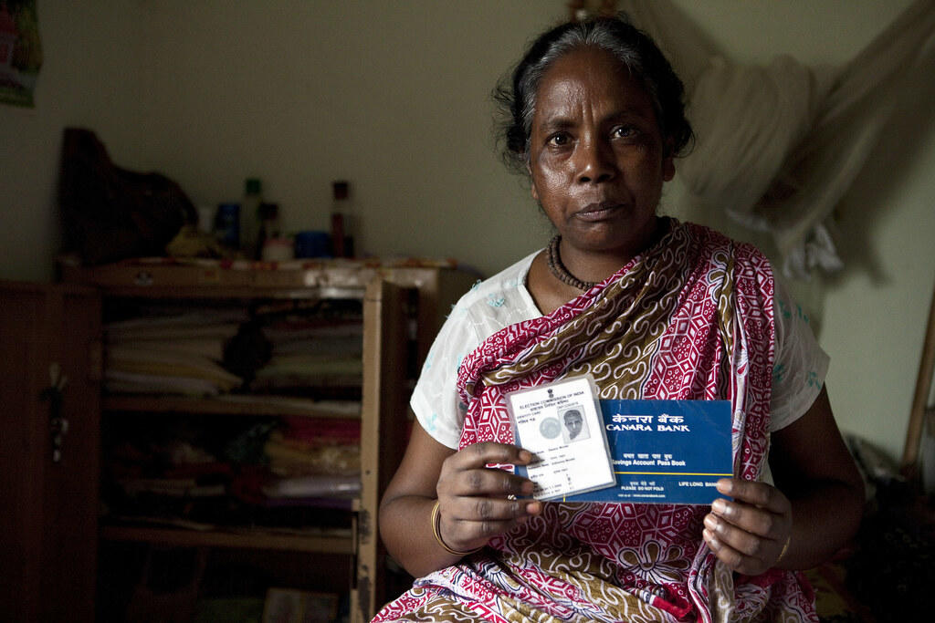 old woman holding ID card