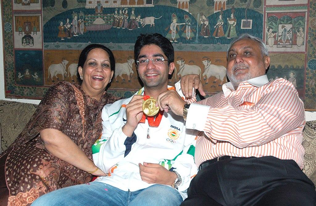 A photo of Abhinav Bindra with his parents at the Delhi airport showing off his gold medal