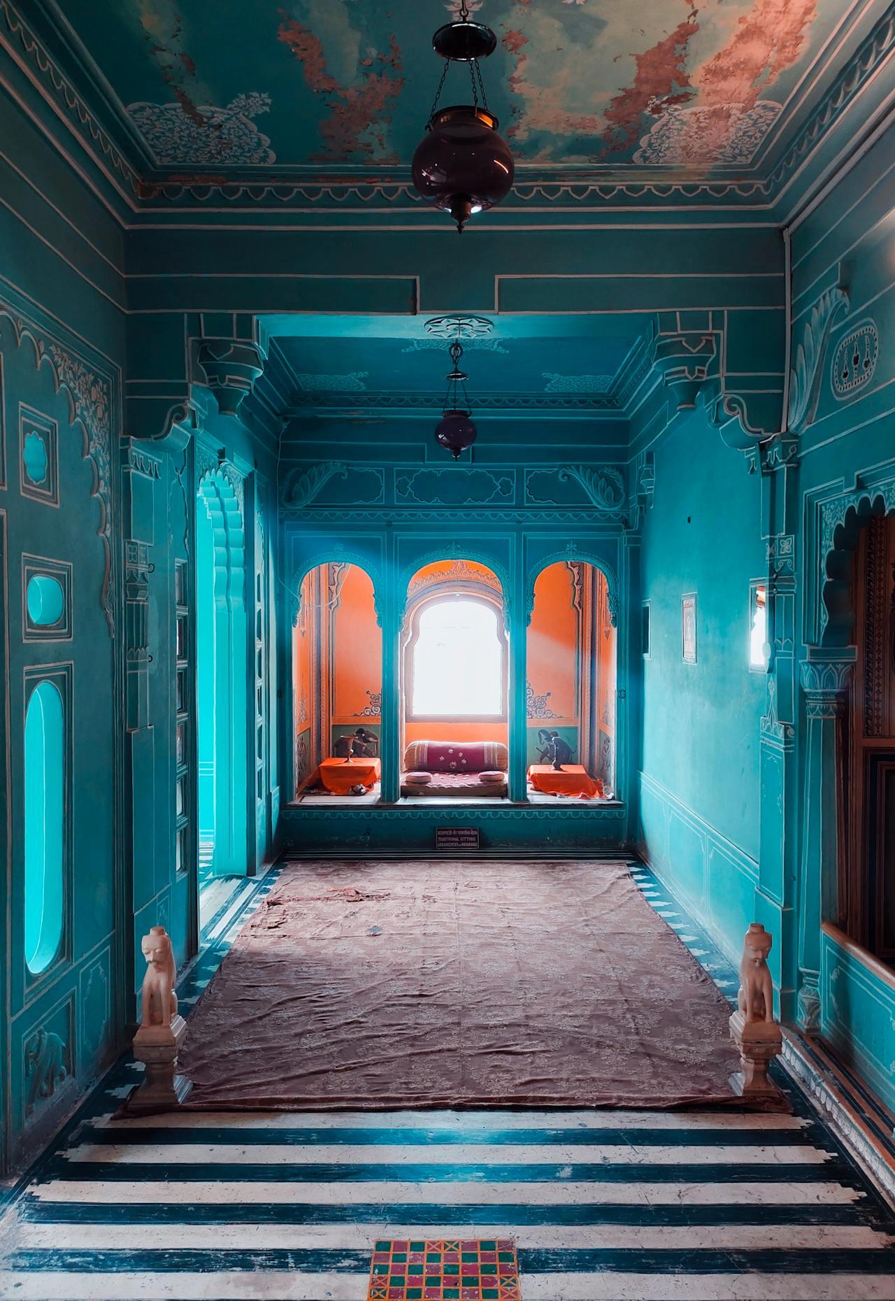 A blue painted corridor inside City Palace