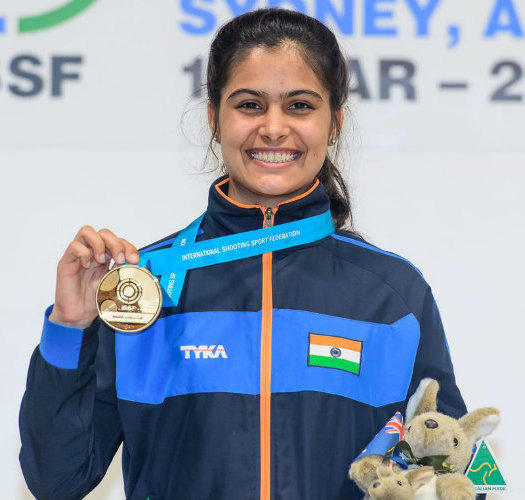 Manu Bhaker holding her gold medal and a stuffed animal mascot.