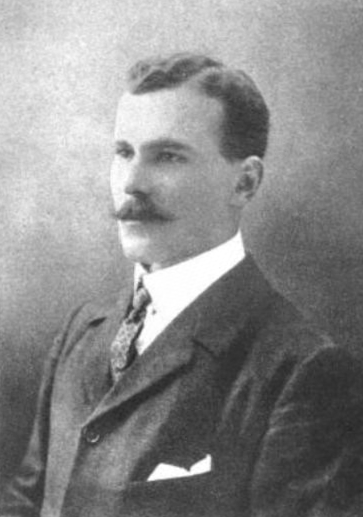 A black and white portrait photo of Norman Pritchard