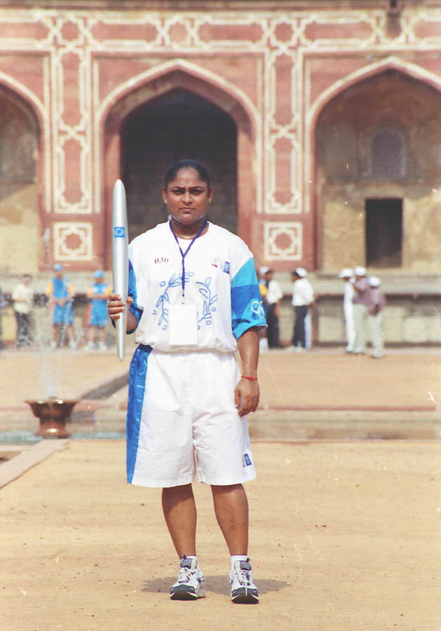 A photo of Karnam Malleswari holding the Olympic torch