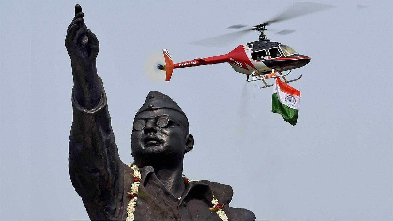 Netaji statue with a helicopter in the background unfurling the Indian tricolor