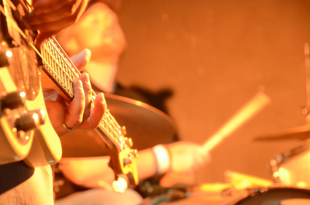 A bass guitarist soloing on the guitar