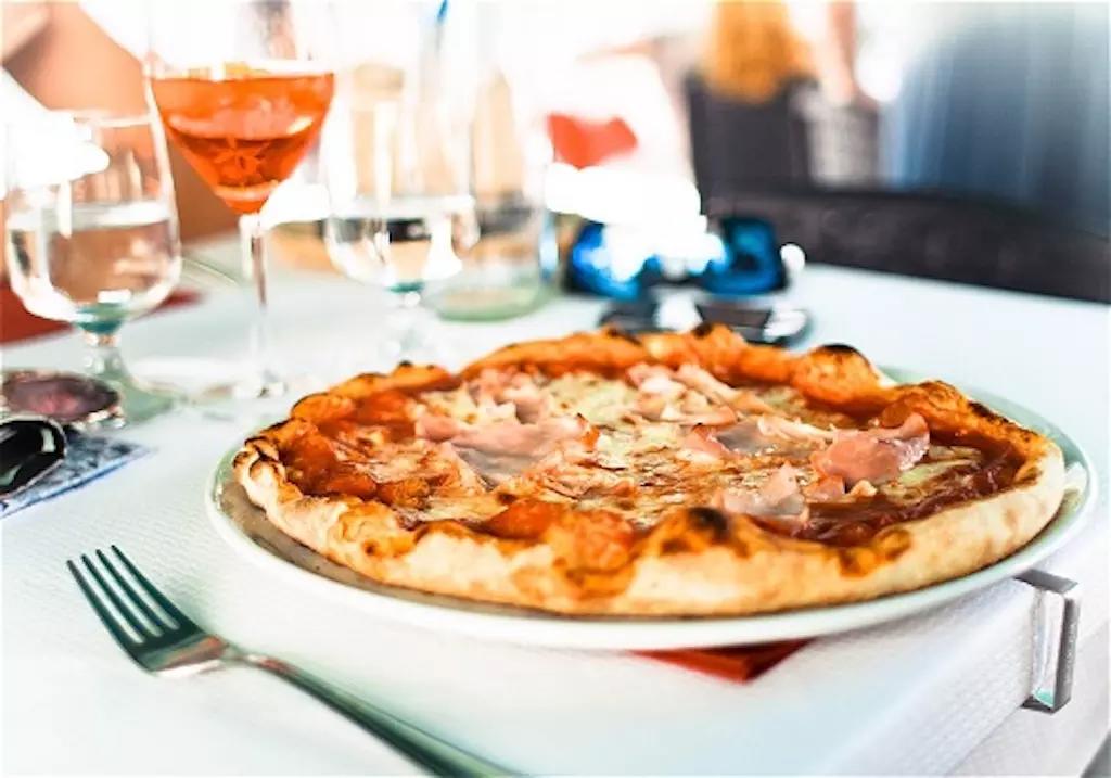 La pizza è un prodotto gastronomico salato che consiste in un impasto a base di farina, acqua e lievito che viene spianato e condito con pomodoro, mozzarella e altri ingredienti e cotto in un forno a legna