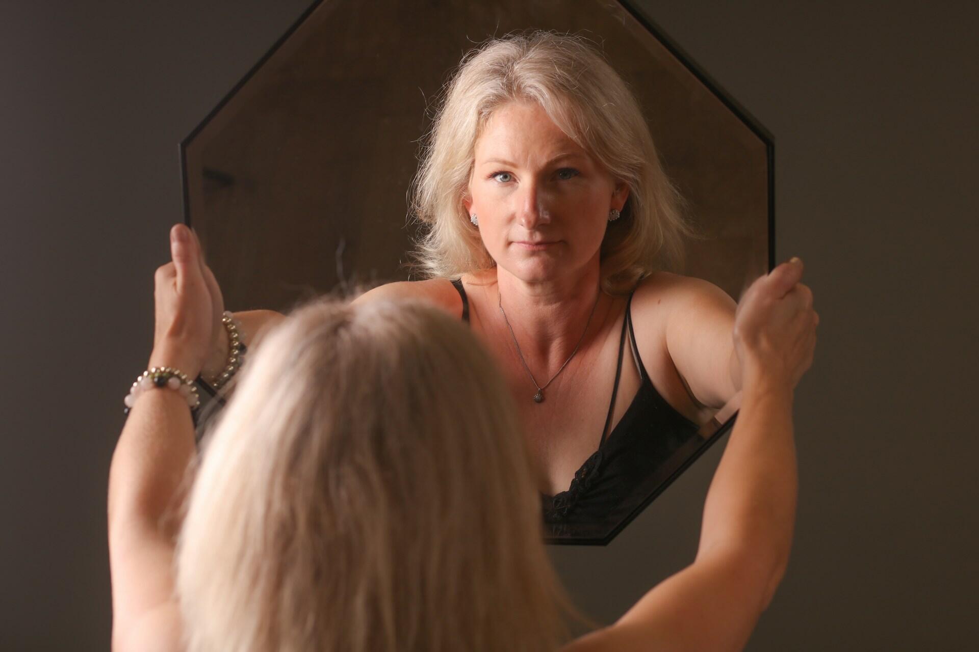 Donna che si guarda allo specchio