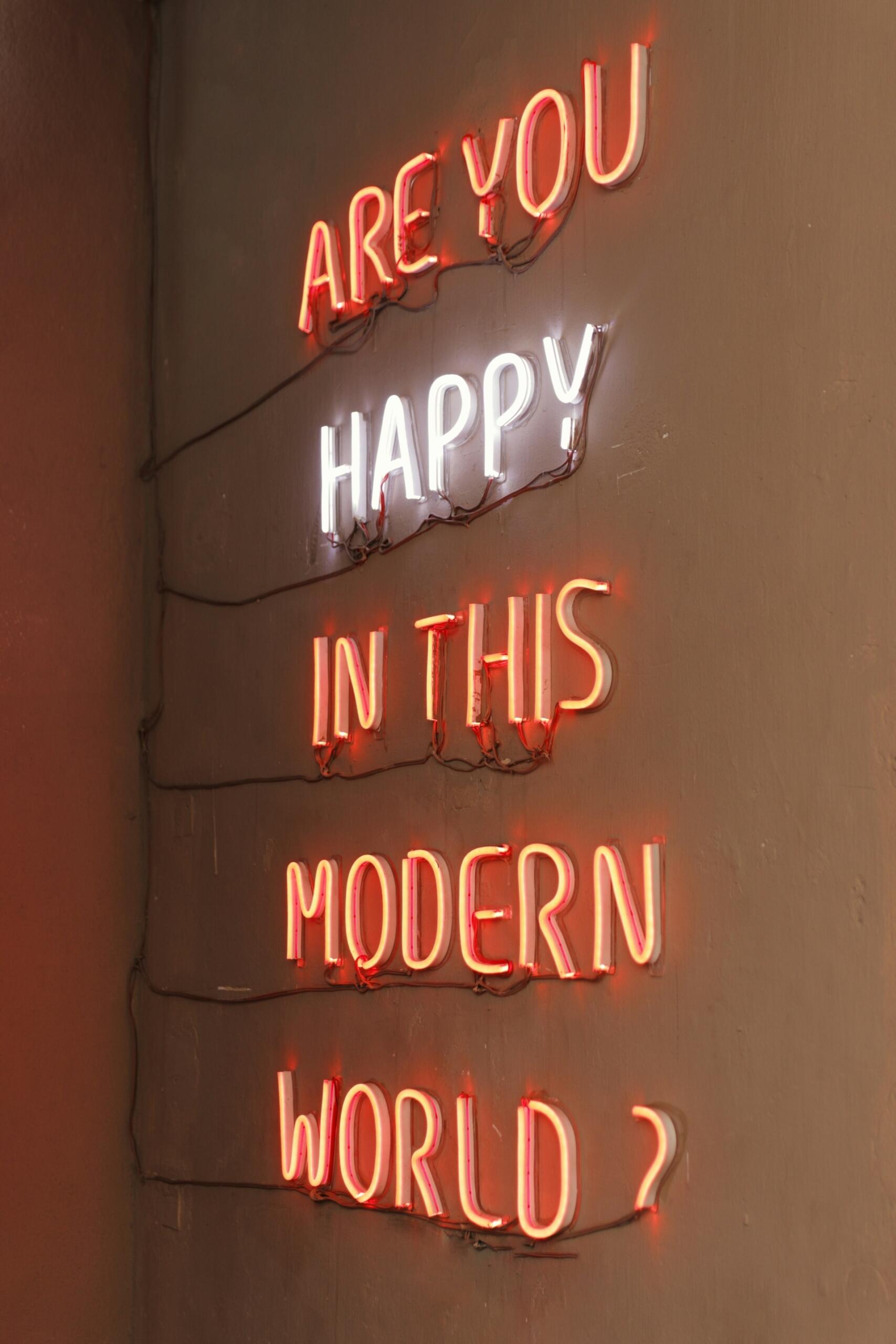 scritta al neon "Are you happy in this modern world?"